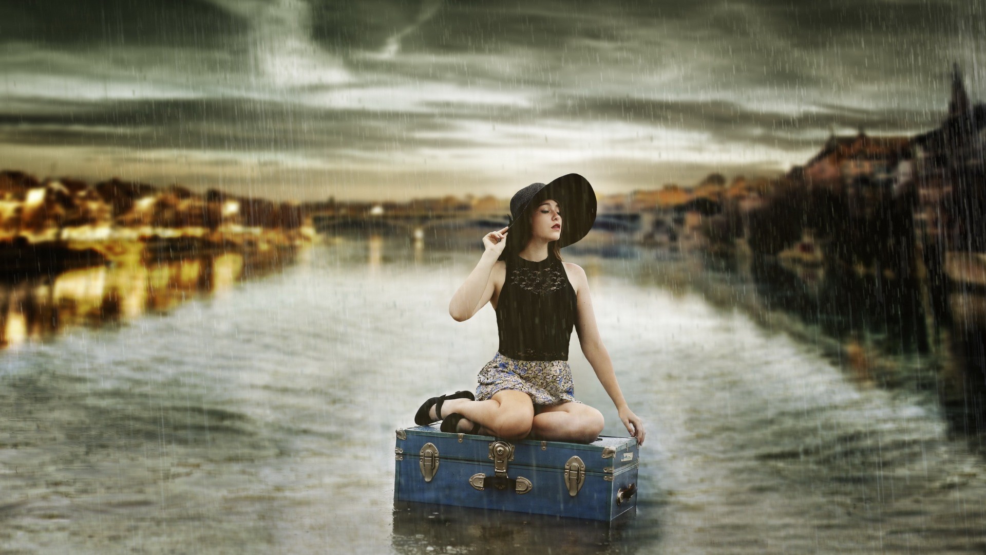 People 1920x1080 women model brunette long hair women outdoors sitting water river suitcase skirt black clothing bare shoulders open mouth closed eyes rain clouds cityscape building hat lights reflection