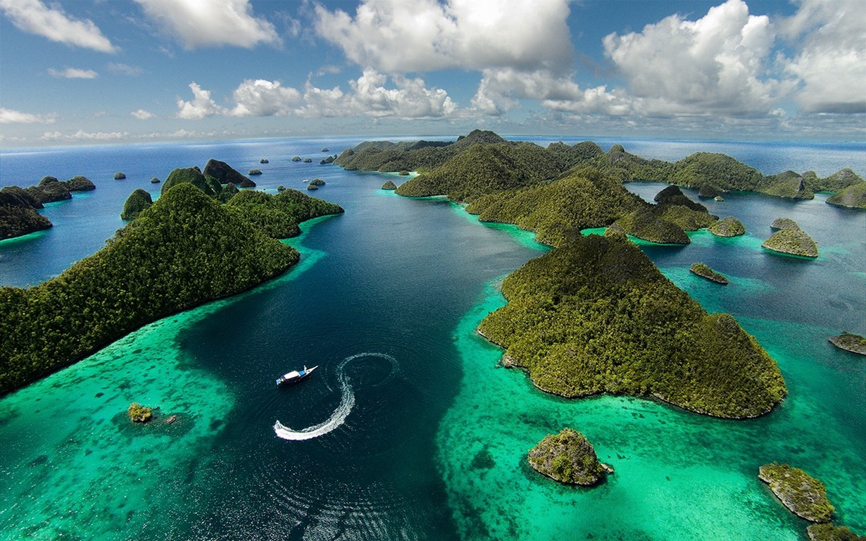 General 1230x768 landscape nature island aerial view Raja Ampat Indonesia tropical sea clouds summer green blue water Asia sky