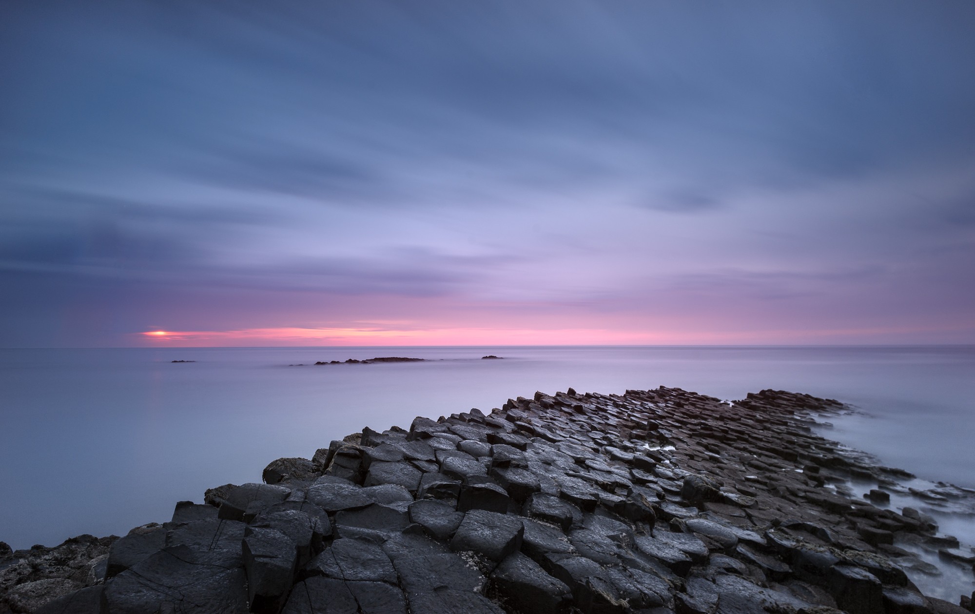 General 2000x1259 nature landscape Giant's Causeway sea waves rocks rock formation long exposure sunset horizon clouds Northern Ireland low light