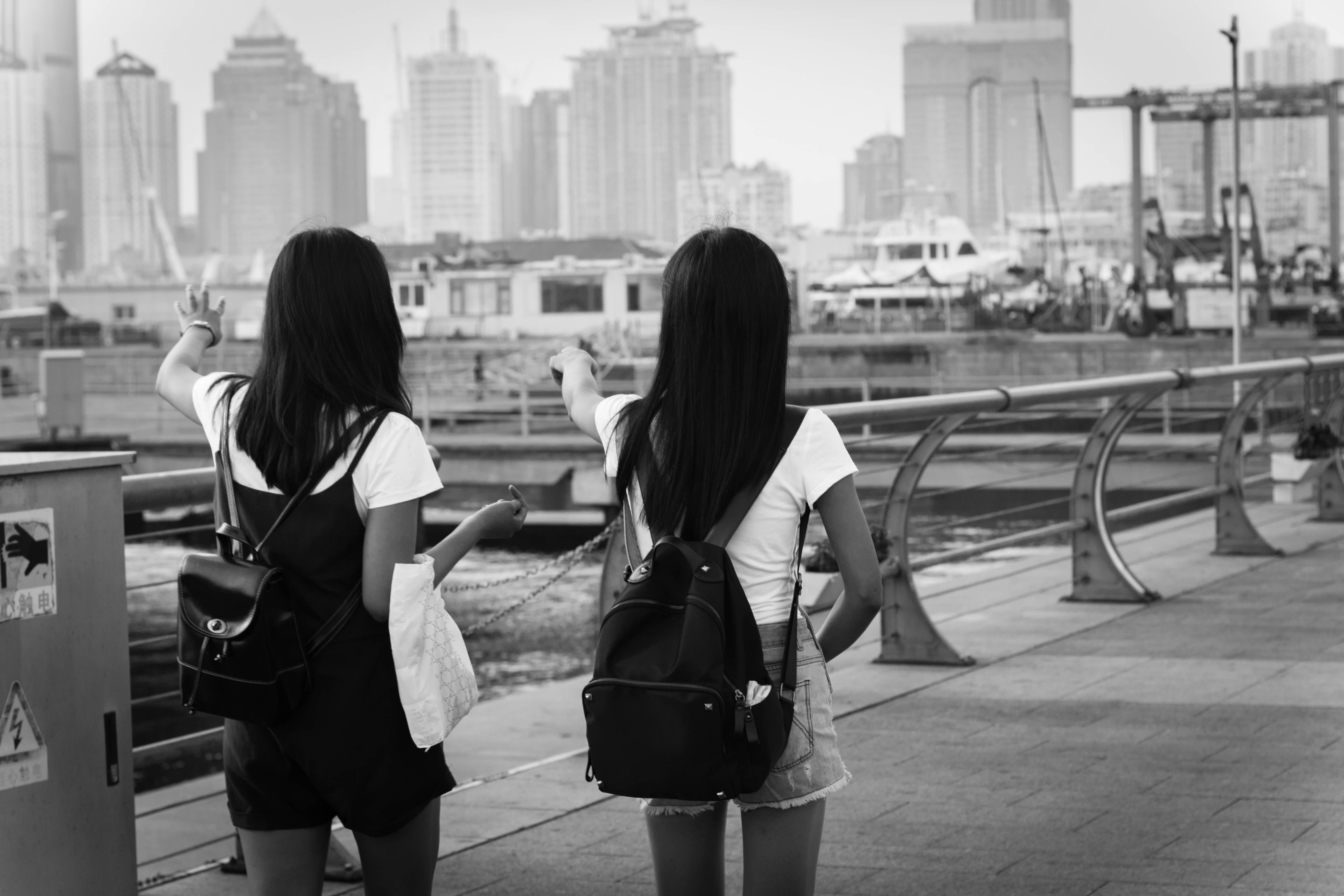 People 5184x3456 monochrome women depth of field tourist T-shirt two women urban cityscape long hair backpacks women outdoors