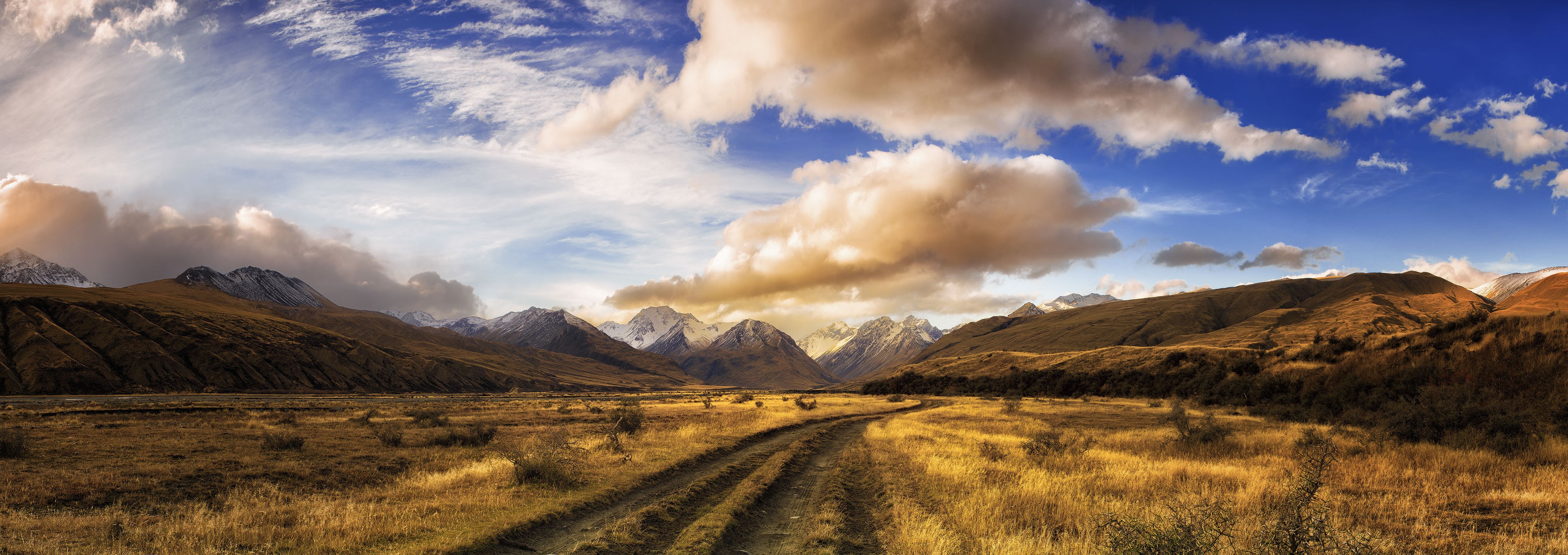 General 4199x1486 nature landscape panorama dirt road dry grass mountains clouds shrubs sunset snowy peak New Zealand