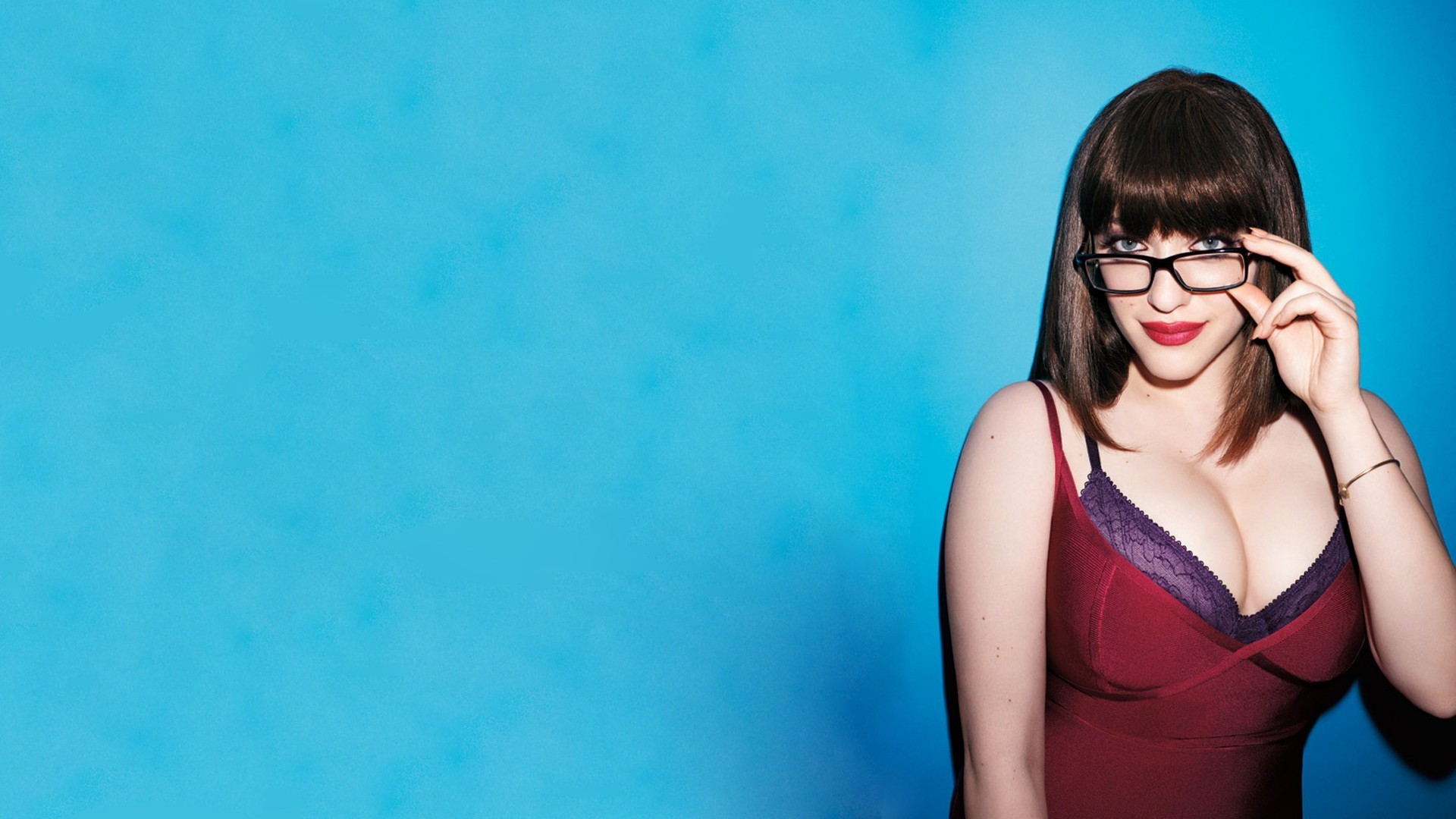 People 1920x1080 Kat Dennings actress brunette cleavage glasses women women with glasses blue blue background cyan cyan background gradient boobs studio women indoors simple background red lipstick looking at viewer