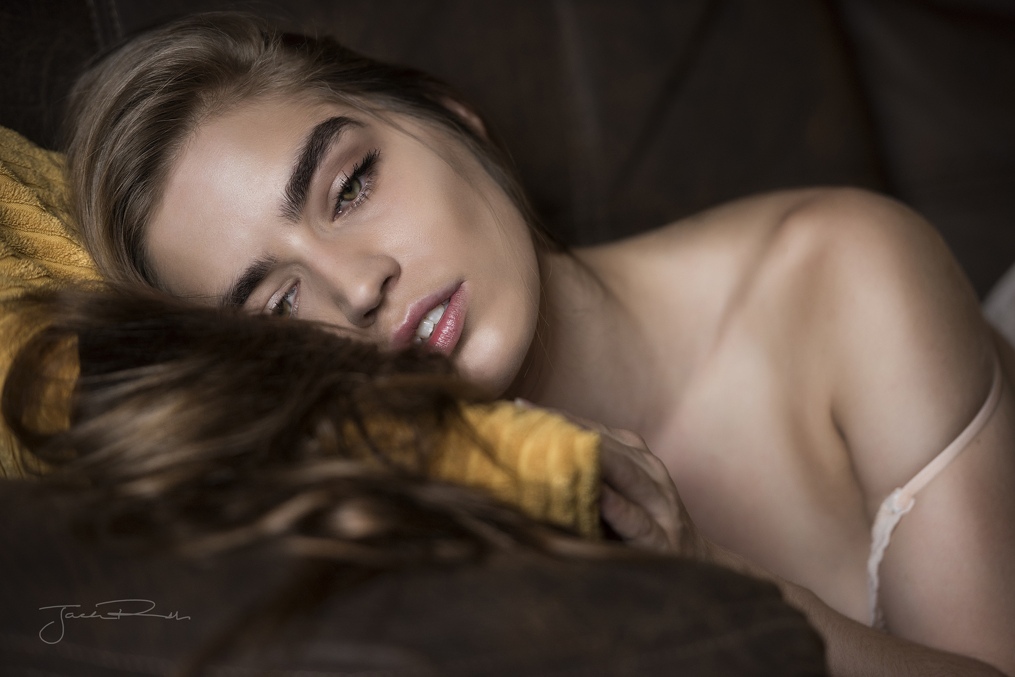 People 2048x1367 women Jack Russell couch brunette lying on front Lily Gilbert signature looking at viewer teeth parted lips lying down long hair depth of field collarbone closeup off shoulder bra straps face watermarked