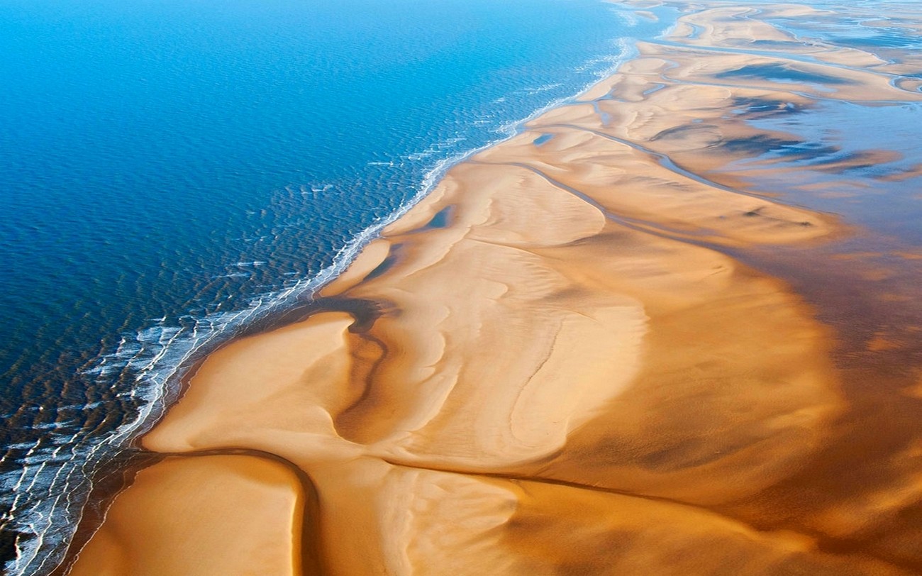 General 1300x812 nature landscape beach sand sea sunlight aerial view UK shore