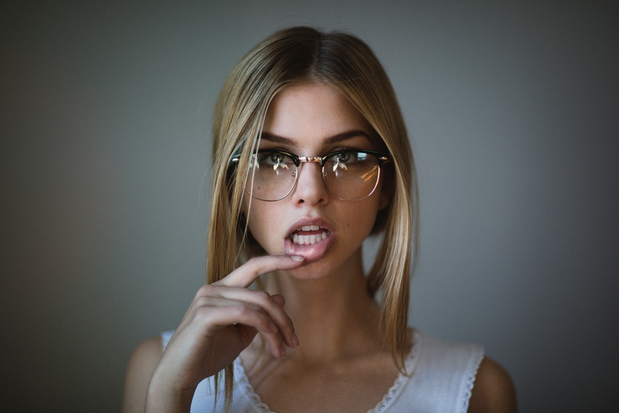People 2048x1365 women blonde face portrait women with glasses finger on lips open mouth glasses parted lips looking at viewer women indoors indoors model simple background