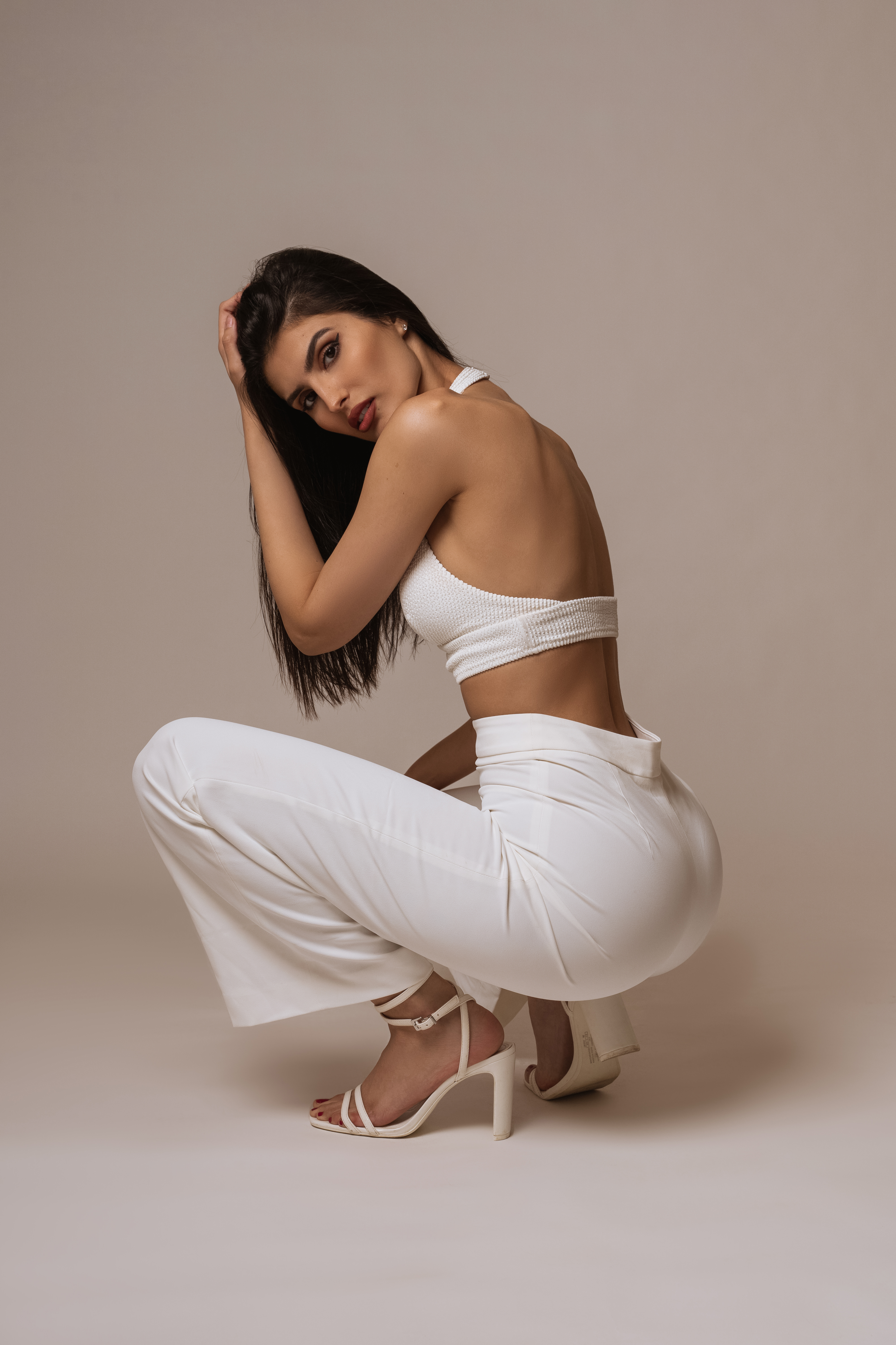 People 4000x6000 model Israeli model simple background portrait display women brunette white clothing squatting ass high heels studio Yael Cohen Aris
