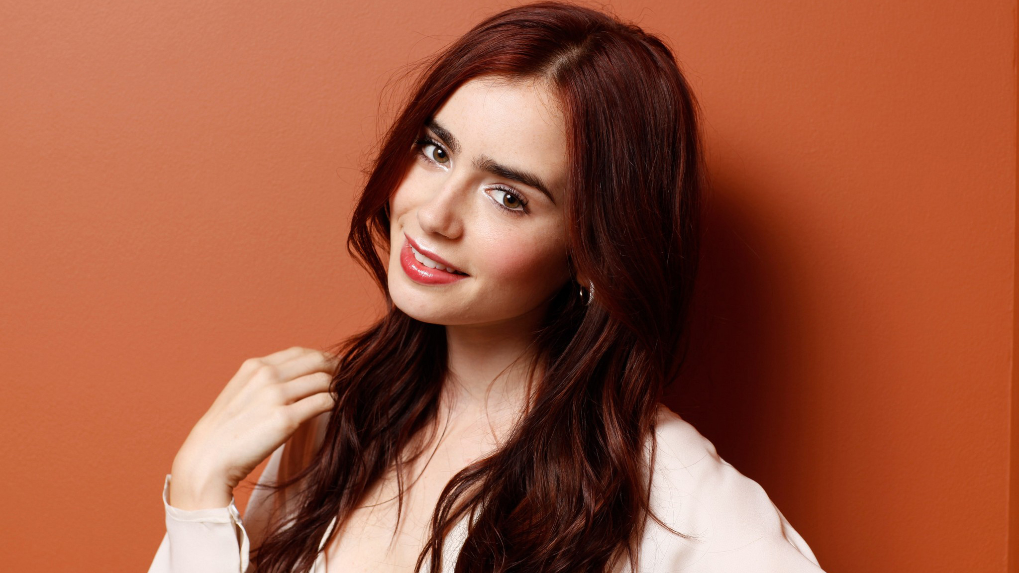 People 2048x1152 Lily Collins actress celebrity brunette women redhead portrait red lipstick happy smiling red background young women looking at viewer British studio British women simple background