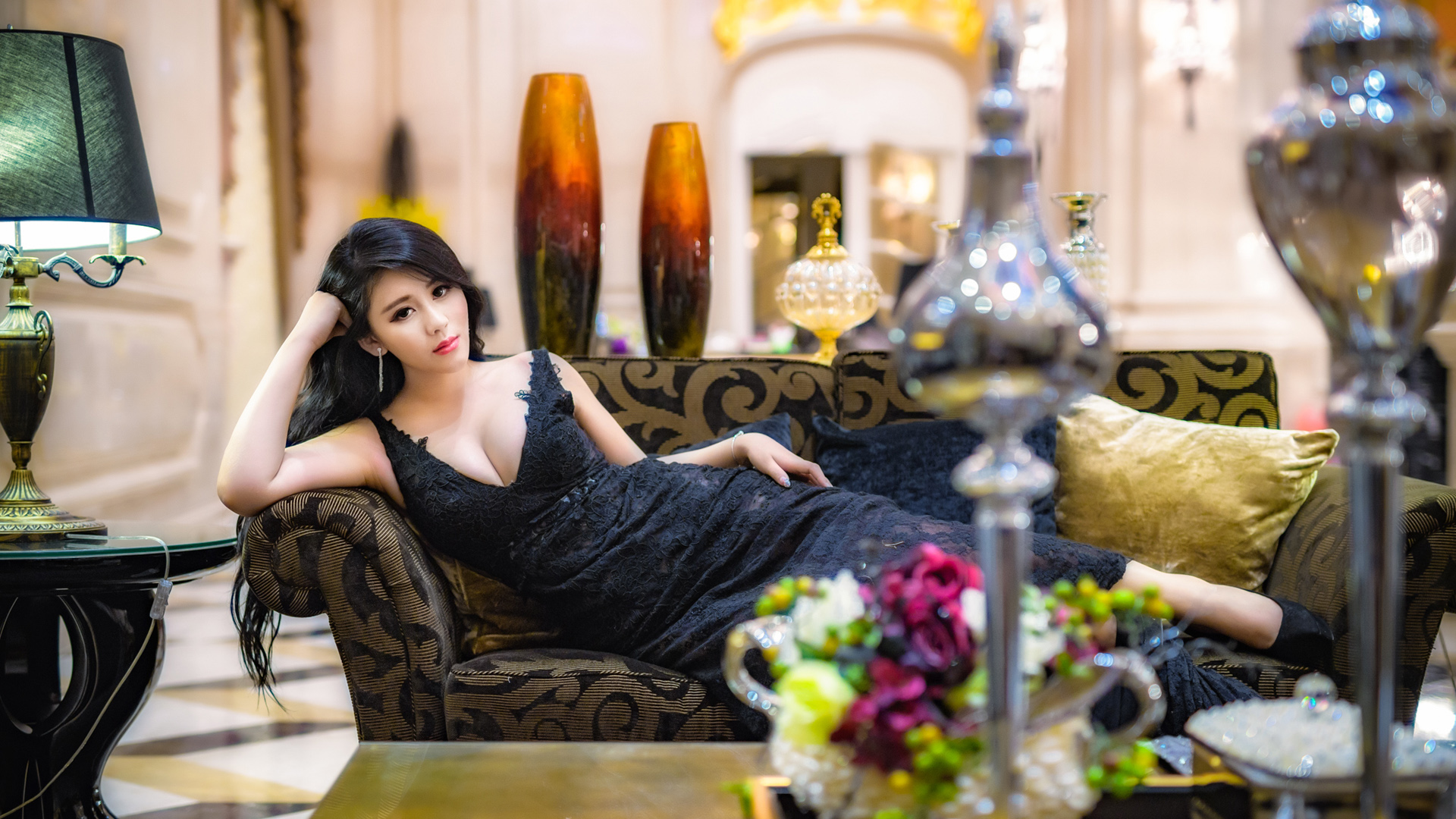 People 1920x1080 women photography model long hair Asian couch looking at viewer black dress cleavage black eyes depth of field