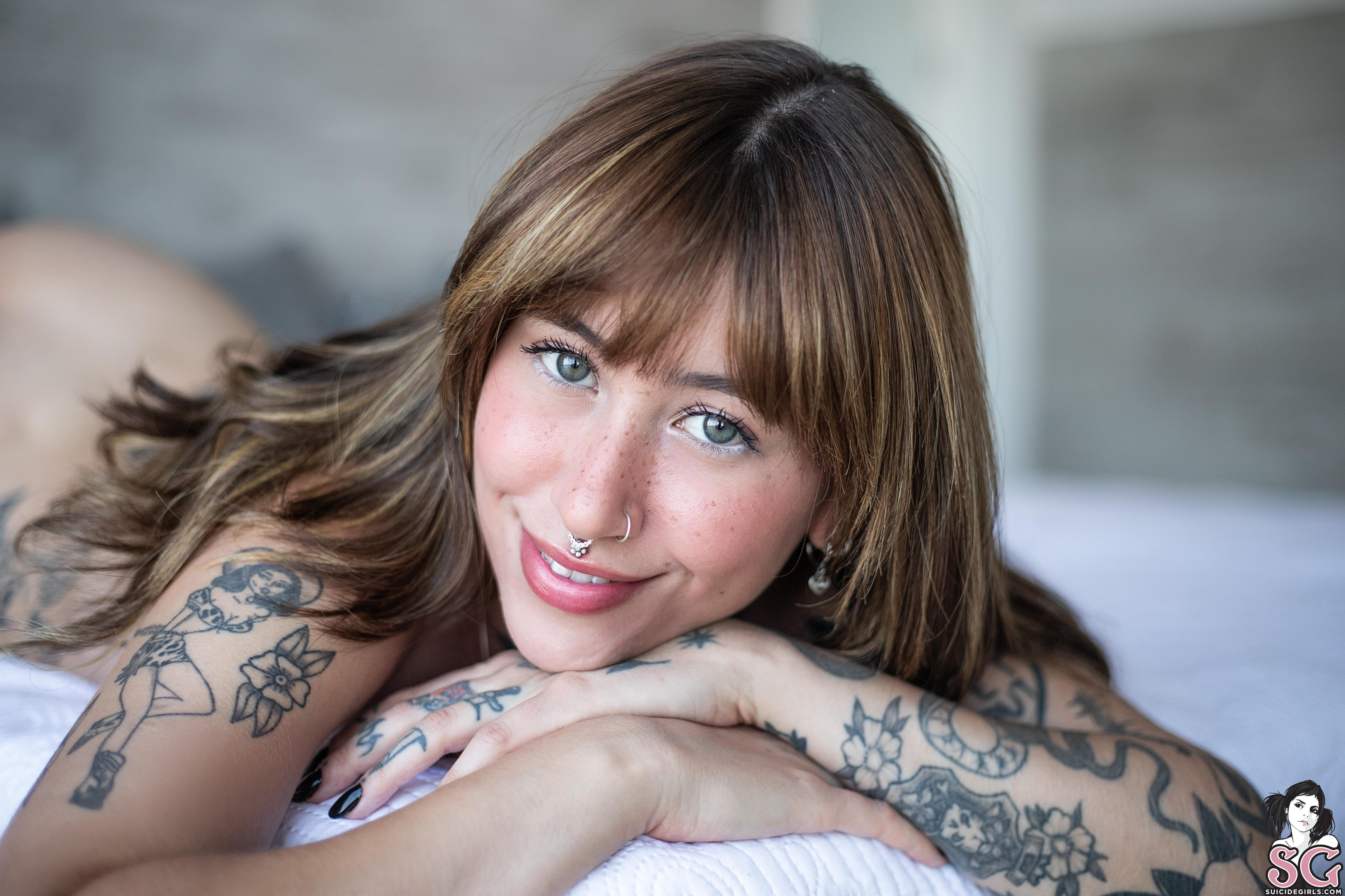 People 3120x2080 Suicide Girls Felline women brunette long hair green eyes inked girls bedroom in bed pillow lying down piercing model smiling nude lying on front pierced nose septum ring tattoo women indoors closeup watermarked
