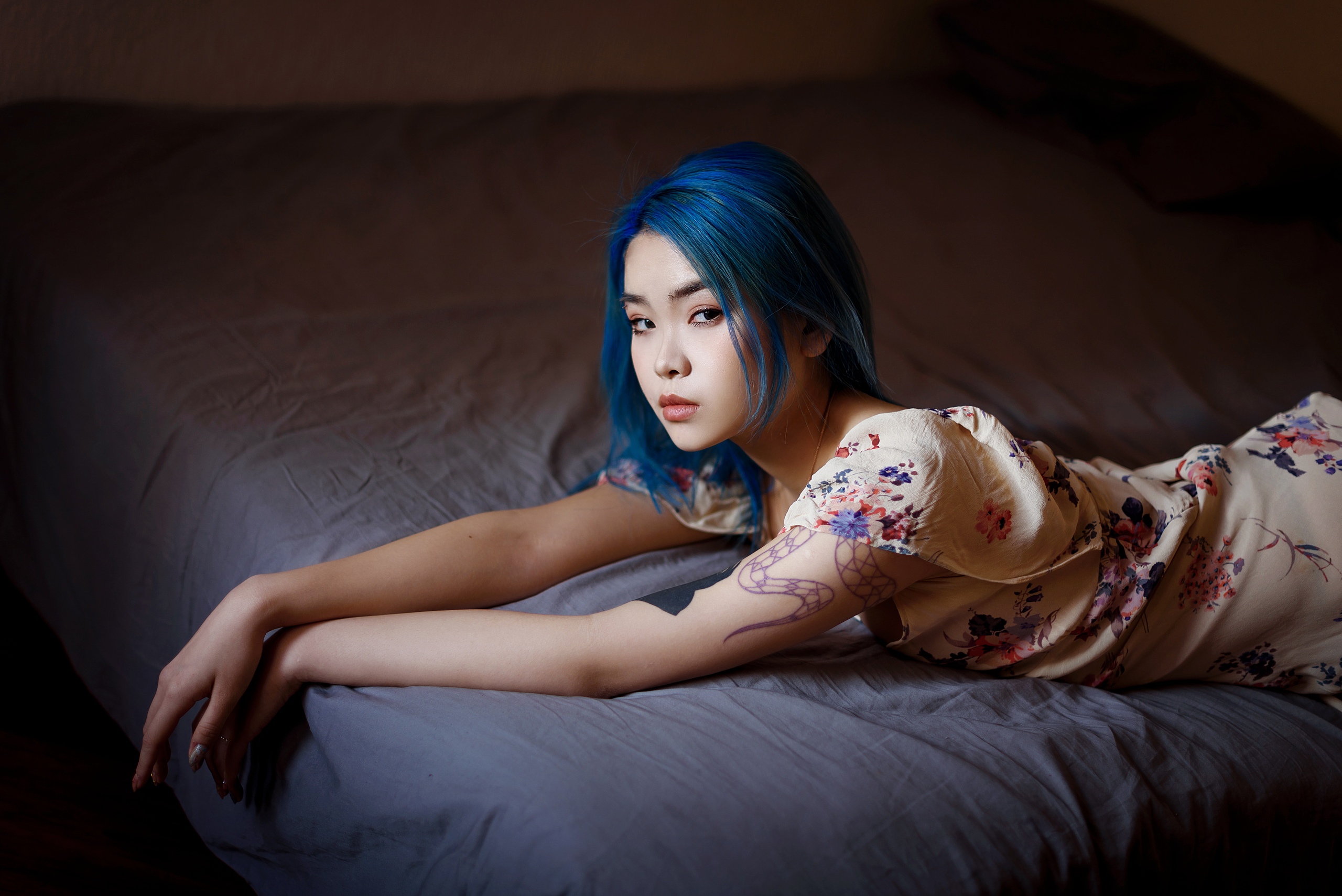 People 2560x1709 women model Asian blue hair dyed hair looking at viewer pierced eyebrow pink lipstick dress lying on front in bed depth of field painted nails inked girls tattoo indoors women indoors