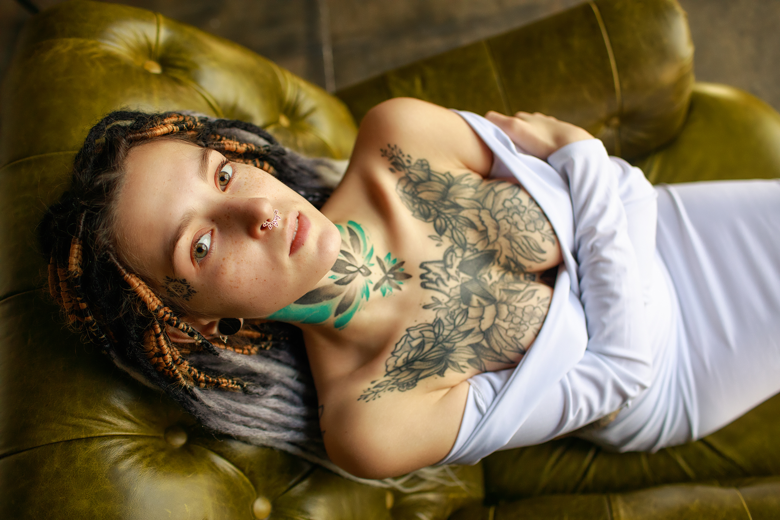 People 2560x1707 inked girls women indoors face lying on back bare shoulders no bra cleavage tattoo green eyes brunette couch model women dress piercing