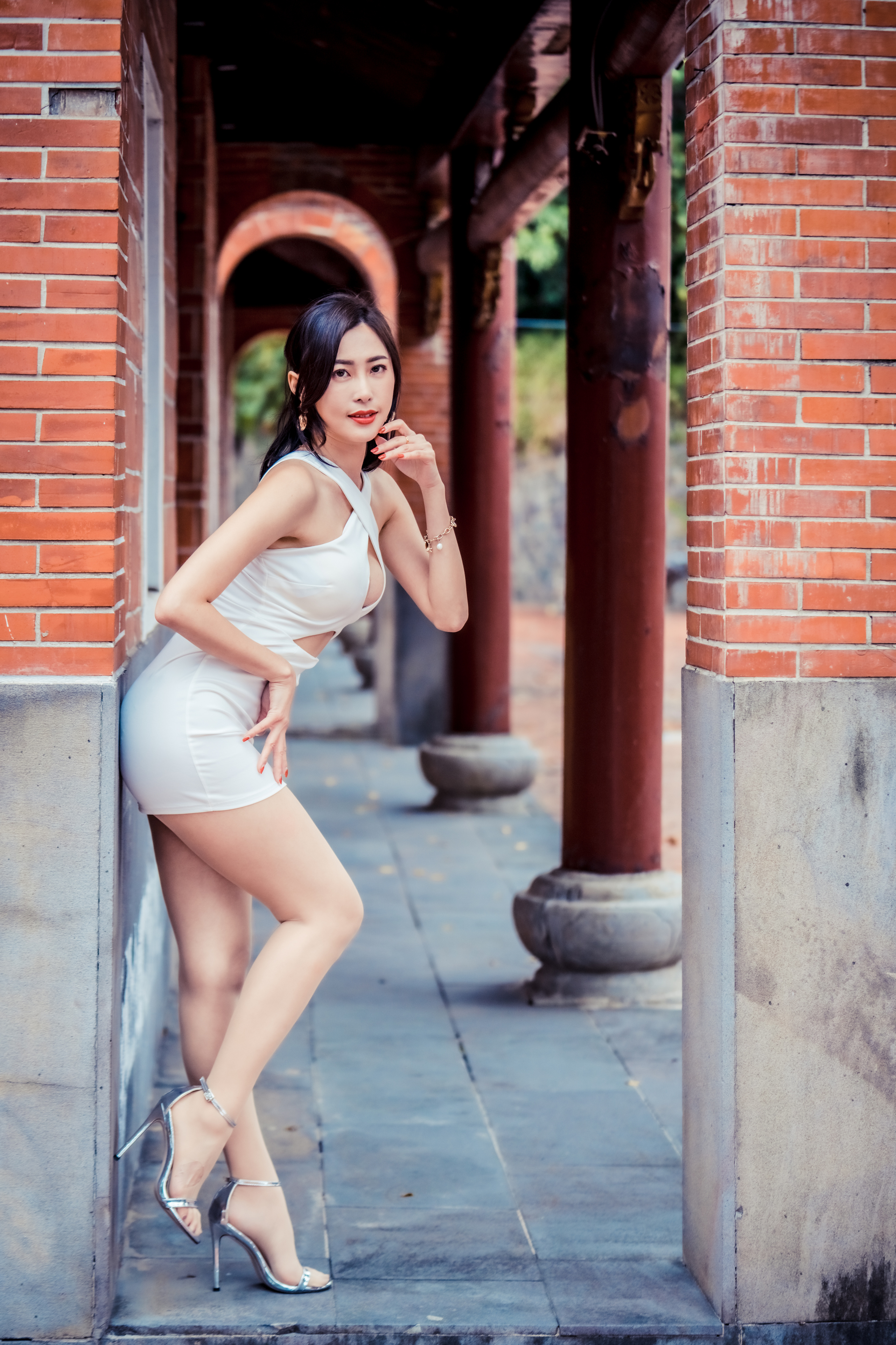 People 2560x3840 Asian model women dark hair long hair depth of field bricks column white dress minidress barefoot sandal heels leaning ponytail bracelets earring