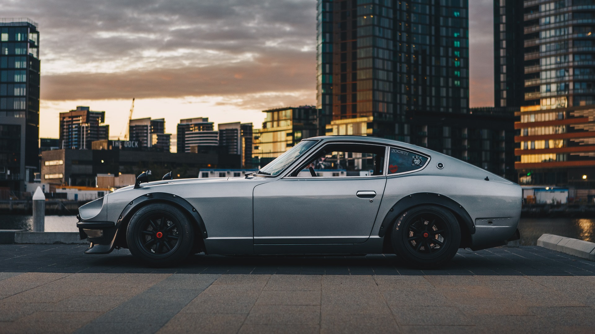 General 1920x1080 Nissan S30 Nissan Fairlady Z Japanese cars sports car Nissan city silver cars car vehicle skyscraper bolt-on fender flares side view gray cars outdoors