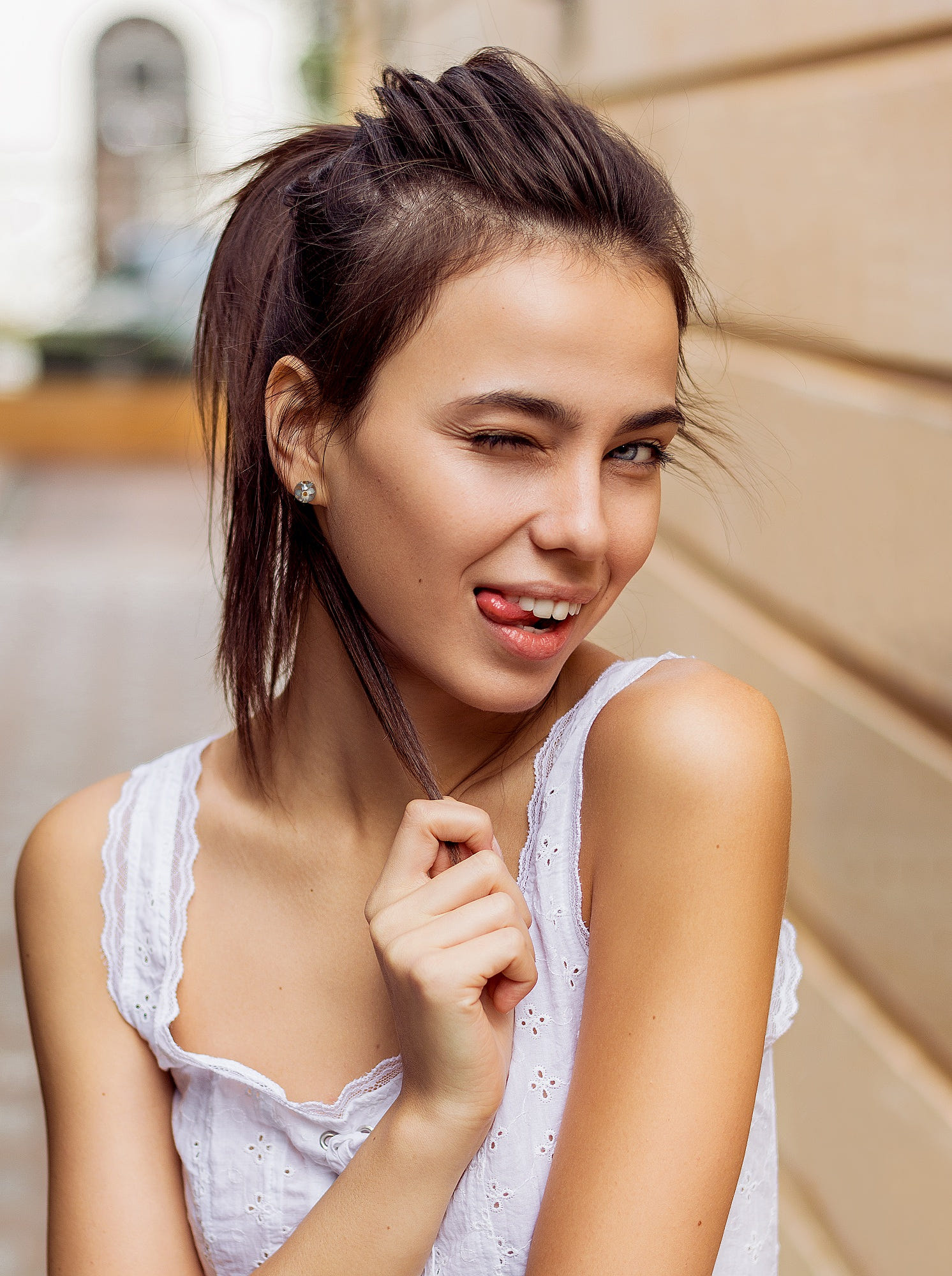 People 1492x2000 Alexandru Zdrobău model women portrait display women outdoors brunette depth of field tongue out white shirt bare shoulders face looking at viewer holding hair gray eyes