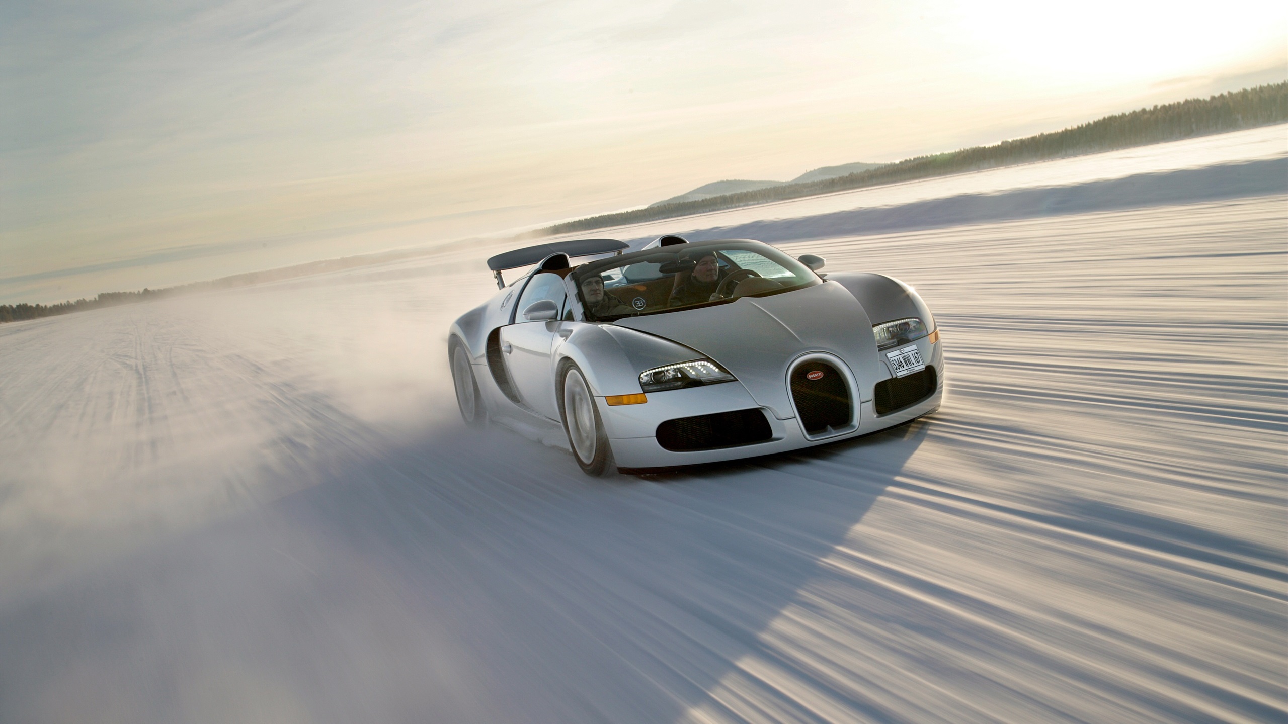General 2560x1440 Bugatti people driving snow winter vehicle road speed-limit hills sky daylight sunlight Bugatti Veyron French Cars Volkswagen Group Hypercar car