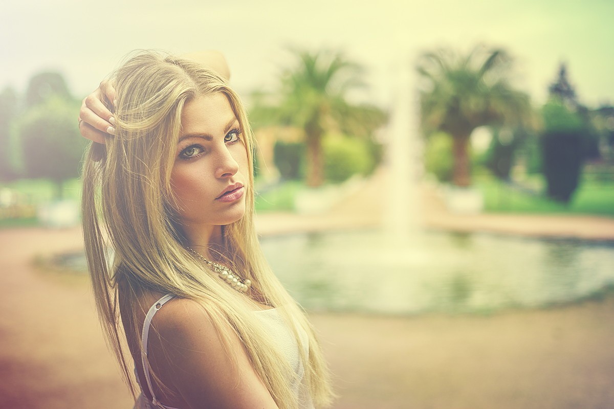People 1200x800 women model blonde long hair women outdoors depth of field nature looking at viewer fountain hand(s) on head bare shoulders palm trees filter pearl necklace pearl earrings