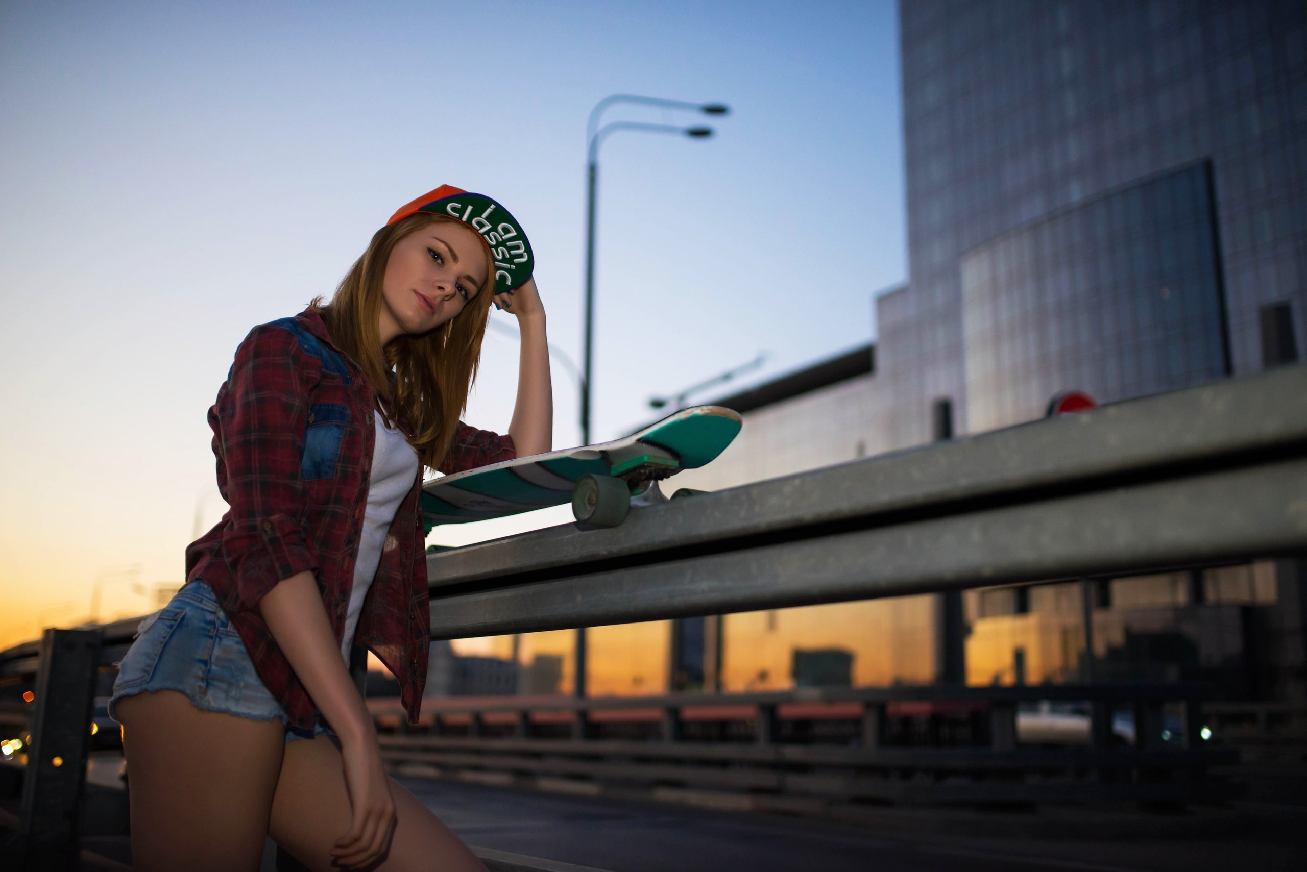 People 2560x1709 women baseball cap jean shorts skateboard sunset shirt portrait looking at viewer depth of field public