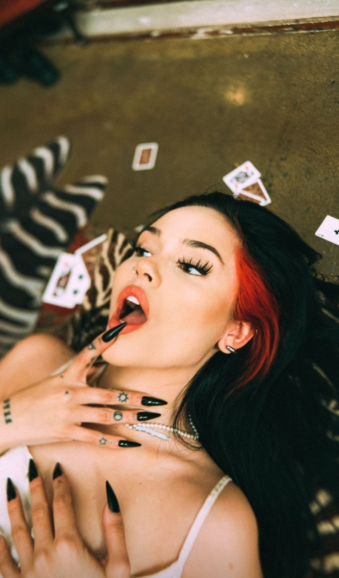 People 1080x1844 model cards playing cards open mouth finger in mouth painted nails fingernails tattoo strand of dyed hair dyed hair lying down looking away women Maggie Lindemann portrait display
