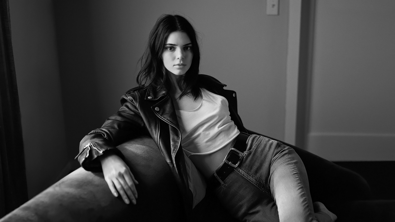 People 1500x844 Kendall Jenner women model brunette dark hair women indoors monochrome jeans leather jacket black jackets sitting