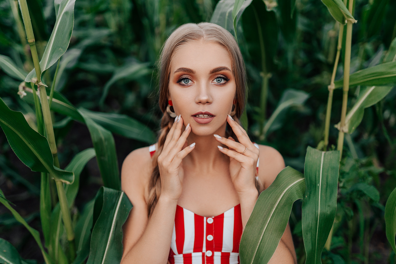 People 1600x1067 Anton Swarovsky women blonde long hair braids makeup eyeliner blue eyes looking at viewer lipstick open mouth painted nails long nails stripes portrait nature plants leaves