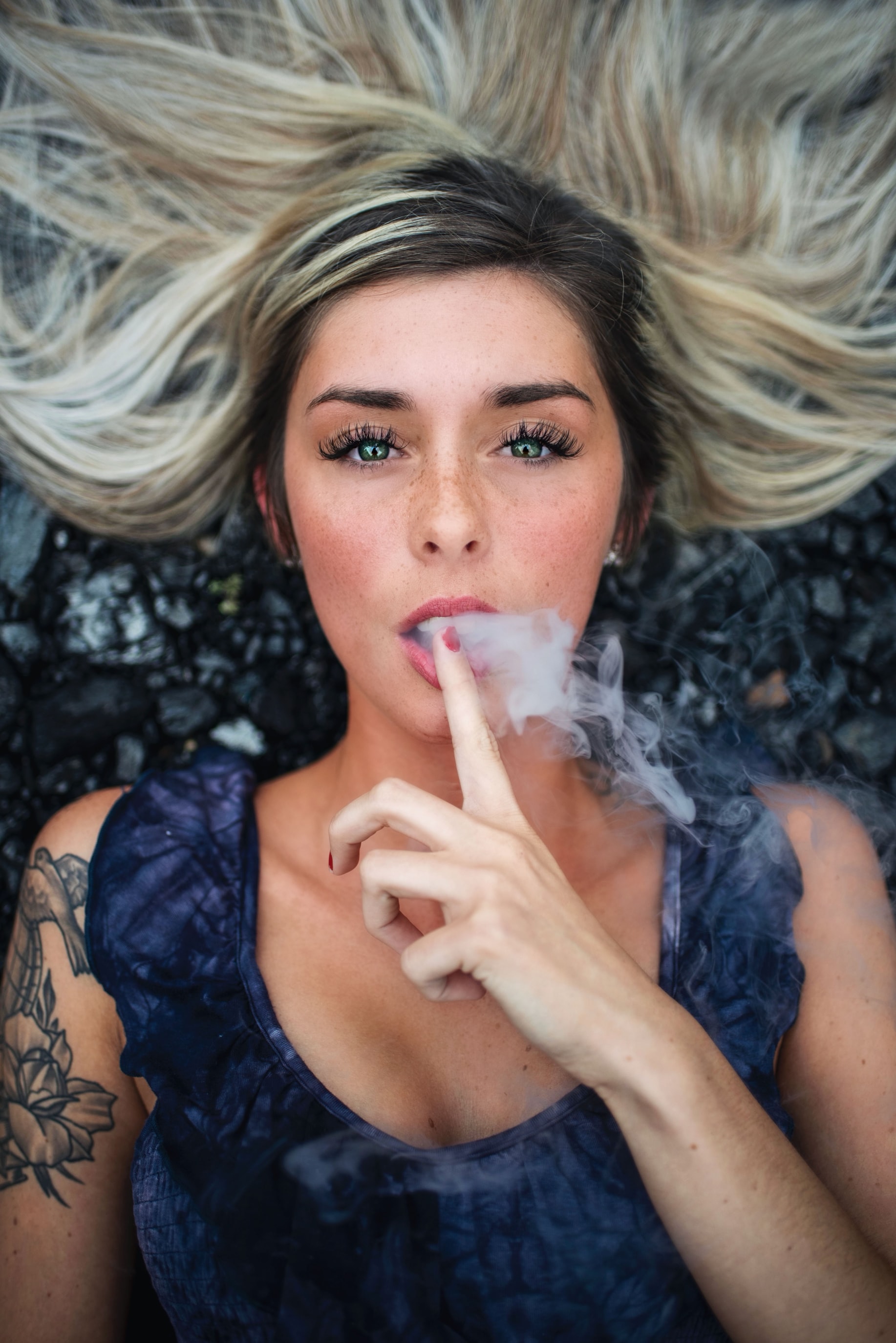 People 1834x2748 women looking at viewer blonde smoke tattoo face open mouth painted nails green eyes portrait display lying on back