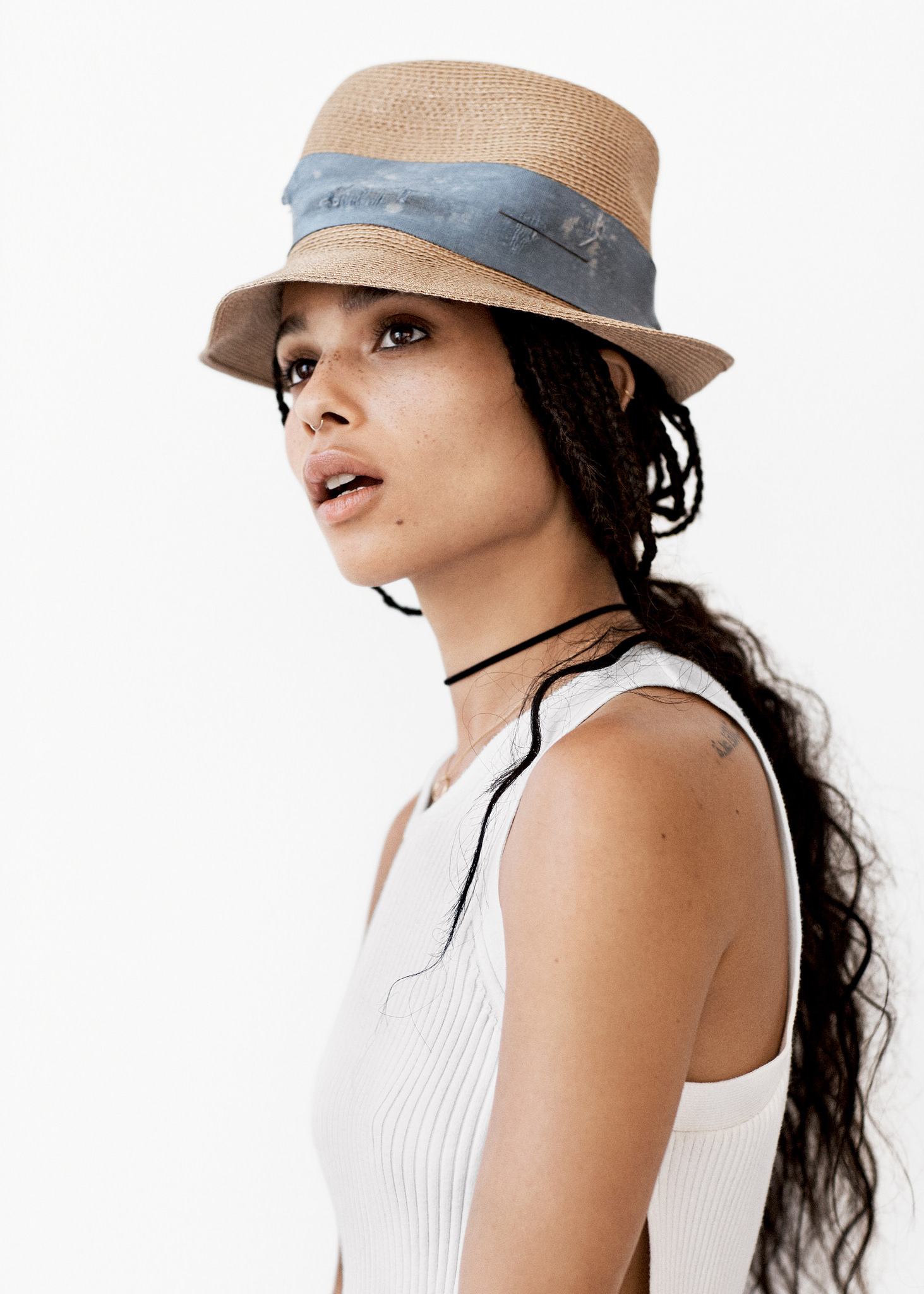 People 1463x2048 Zoë Kravitz women model long hair white background simple background dark skin actress singer hat tattoo looking into the distance celebrity brunette braids brown eyes freckles nose ring white tank top bare shoulders open mouth studio