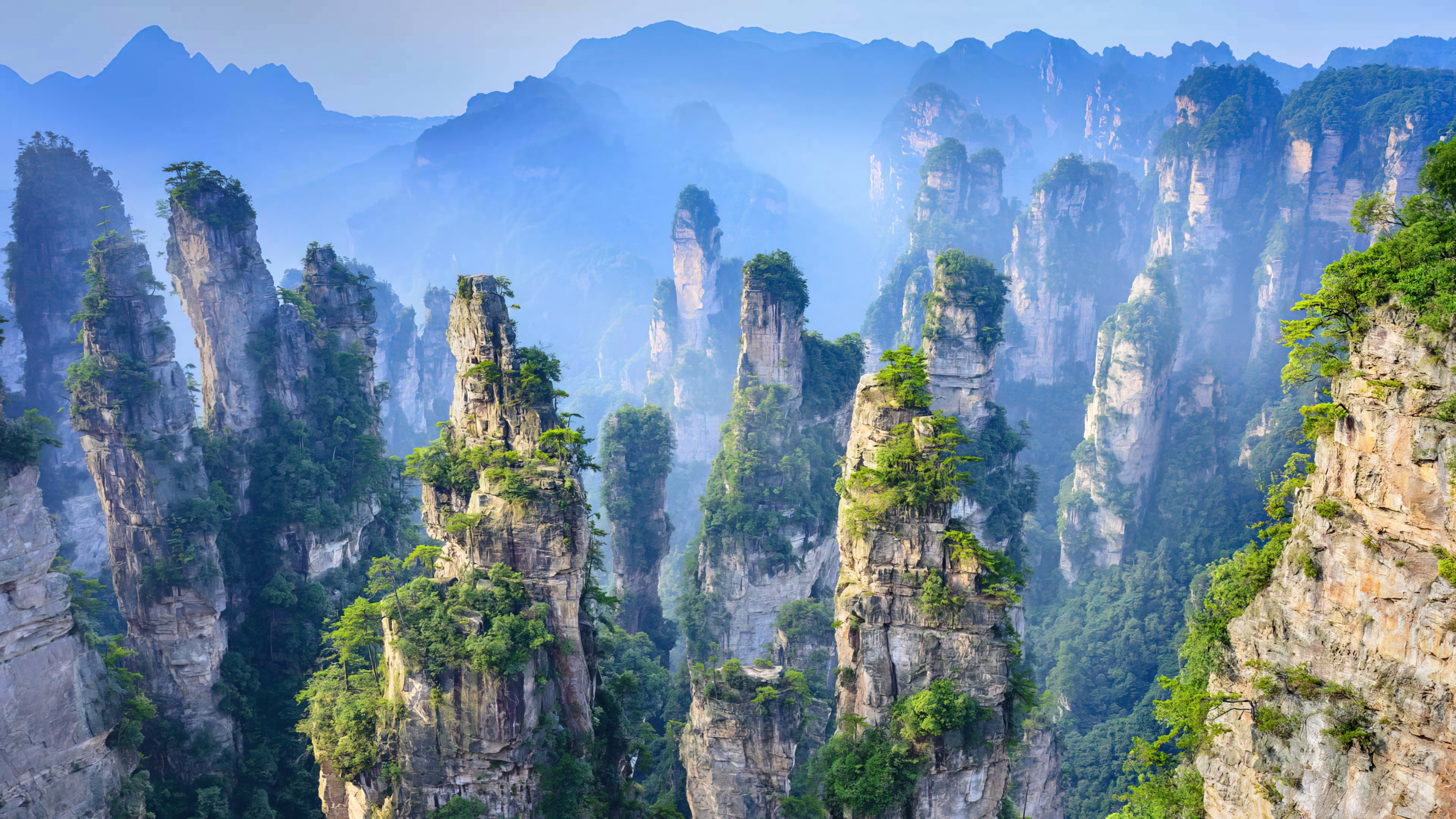 General 3840x2160 mountains Basin Mountain nature World Heritage Site Heritage Asia Hunan Zhangjiajie National Park  clear sky China landscape trees clouds cliff