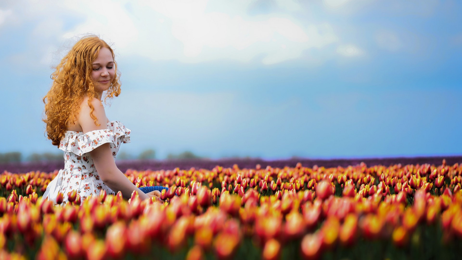 People 1920x1080 women model redhead long hair women outdoors curly hair bare shoulders smiling closed eyes dress field flowers tulips depth of field Agro (Plants) plants summer dress white clothing sitting sky outdoors dyed hair