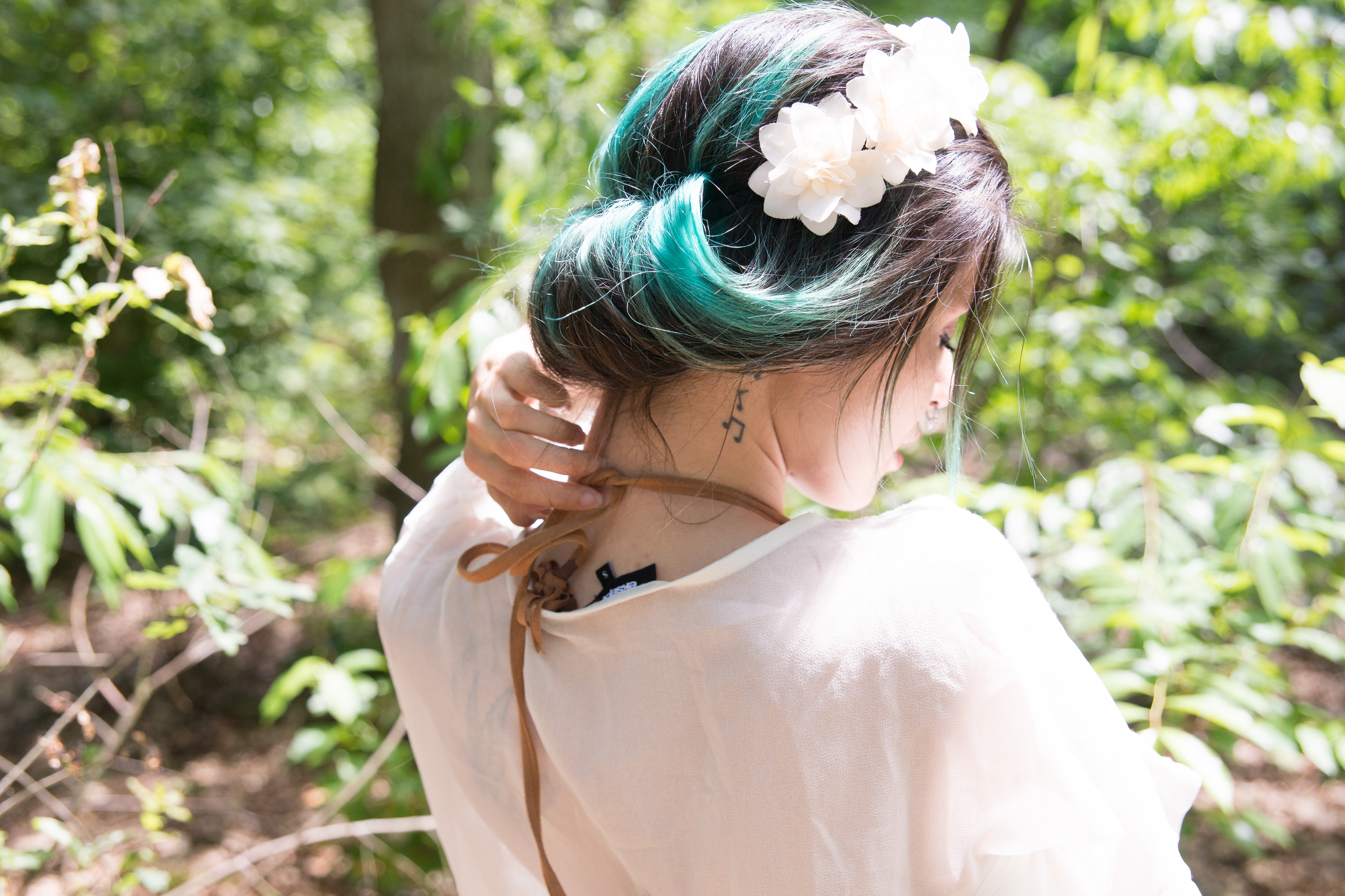 People 6000x4000 Nova Anne Dutch women women outdoors photography model forest trees leaves sensual gaze piercing tattoo see-through clothing depth of field closed eyes undressing removing bra flower crown dyed hair sun rays back cyan hair closeup rear view