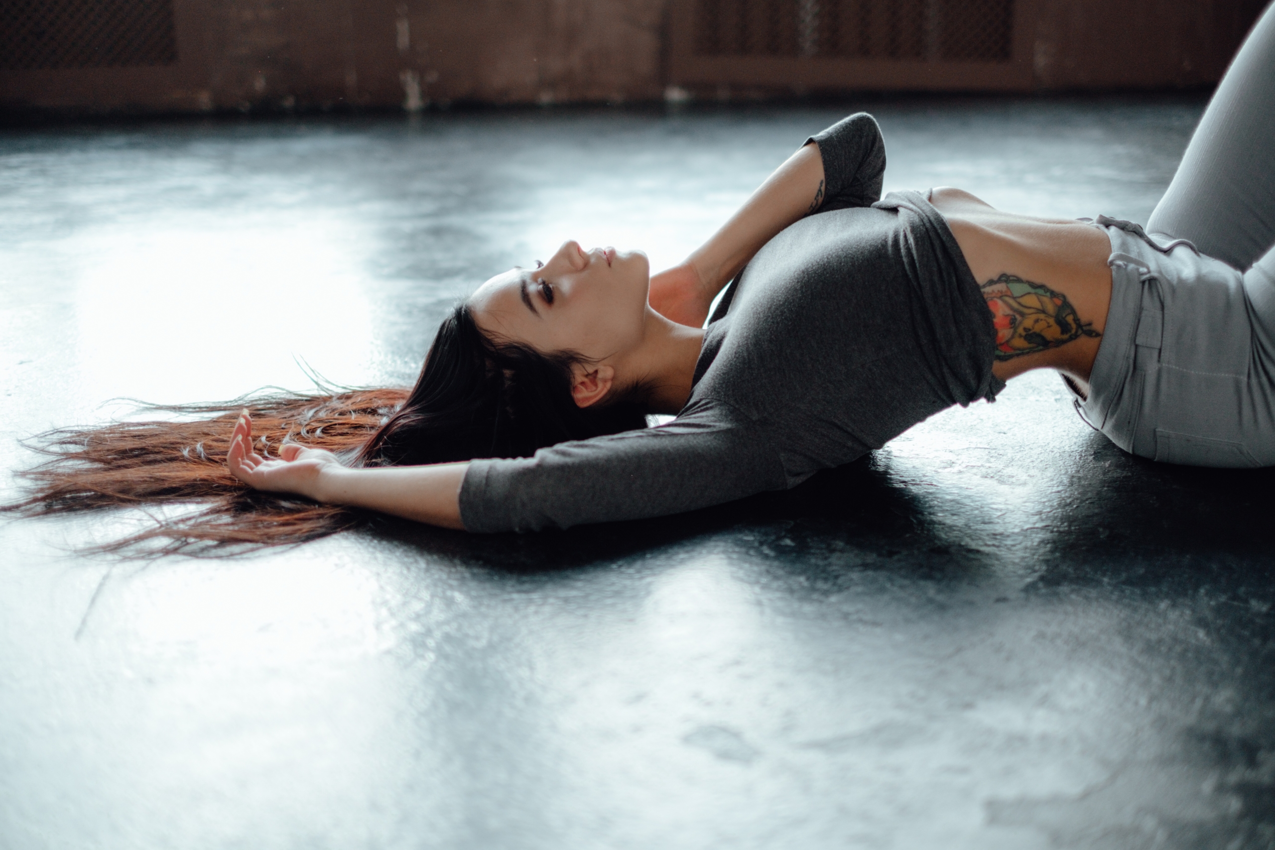 People 2560x1707 Aleksa Tereschuk women model brunette long hair looking up profile lying on back arched back grey tops belly jeans tattoo inked girls on the floor depth of field indoors women indoors side view