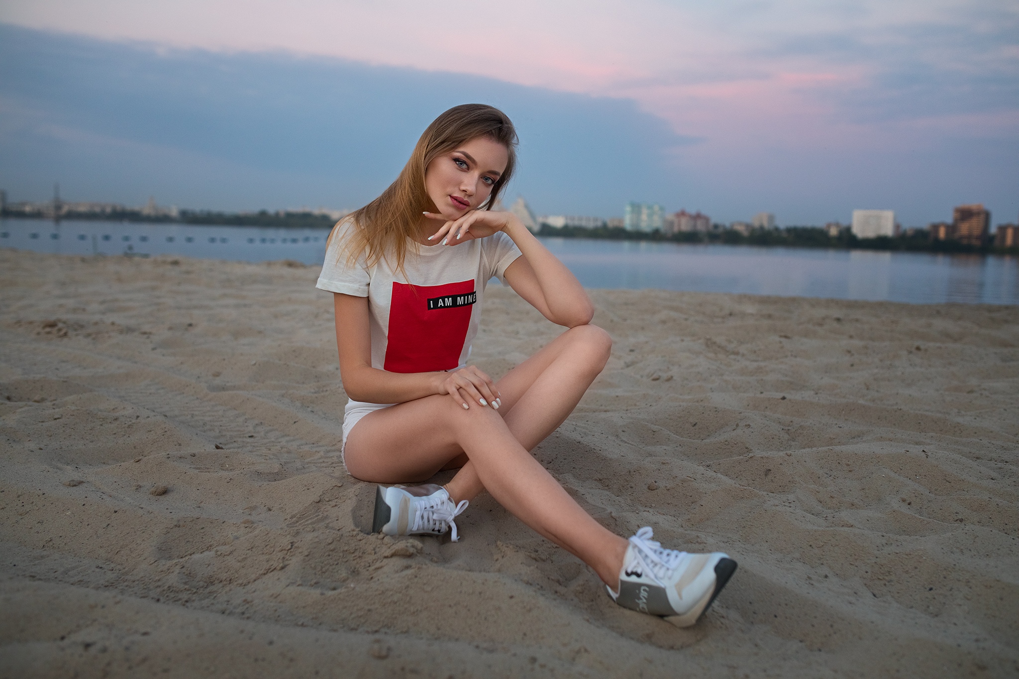 People 2048x1365 women model blonde looking at viewer touching face white nails painted nails T-shirt short shorts jean shorts legs legs crossed sneakers sitting beach women on beach portrait outdoors Dmitry Shulgin
