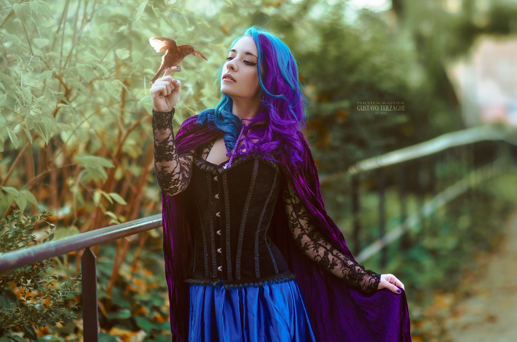 People 2000x1324 Gustavo Terzaghi women long hair wavy hair blue hair purple hair multi-colored hair corset cape skirt birds nature fence plants green black blue clothing purple makeup pierced nose Saria Suicide