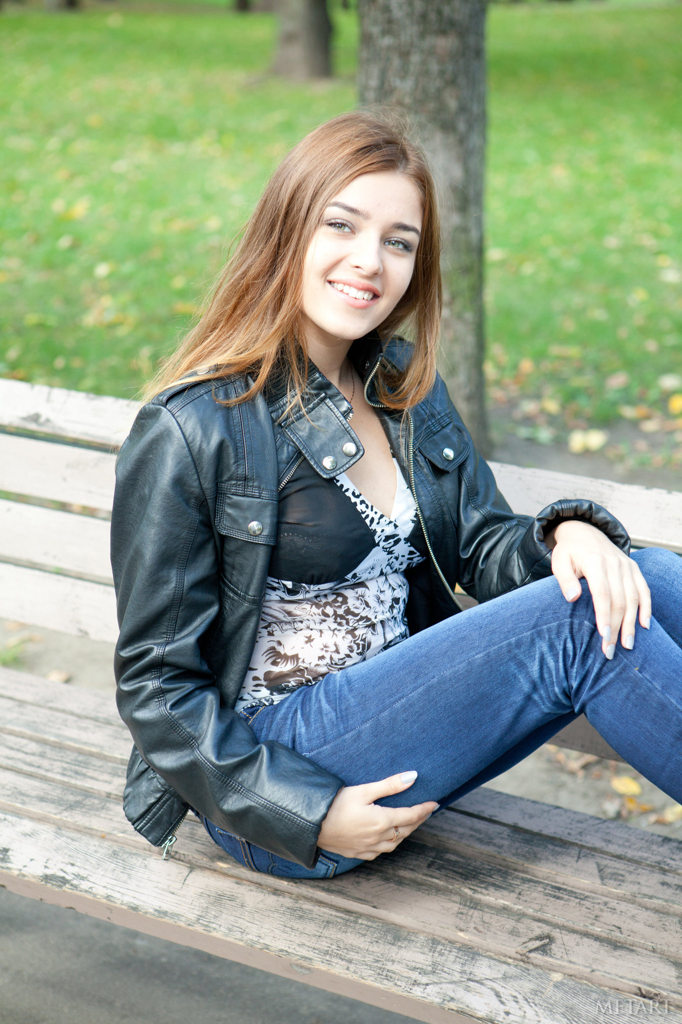 People 1365x2048 Adriana Morriss model women outdoors looking at viewer leather jacket bench sitting brunette smiling long hair black jackets MetArt happy pale open jacket jacket on bench blue  jeans blue pants women portrait display