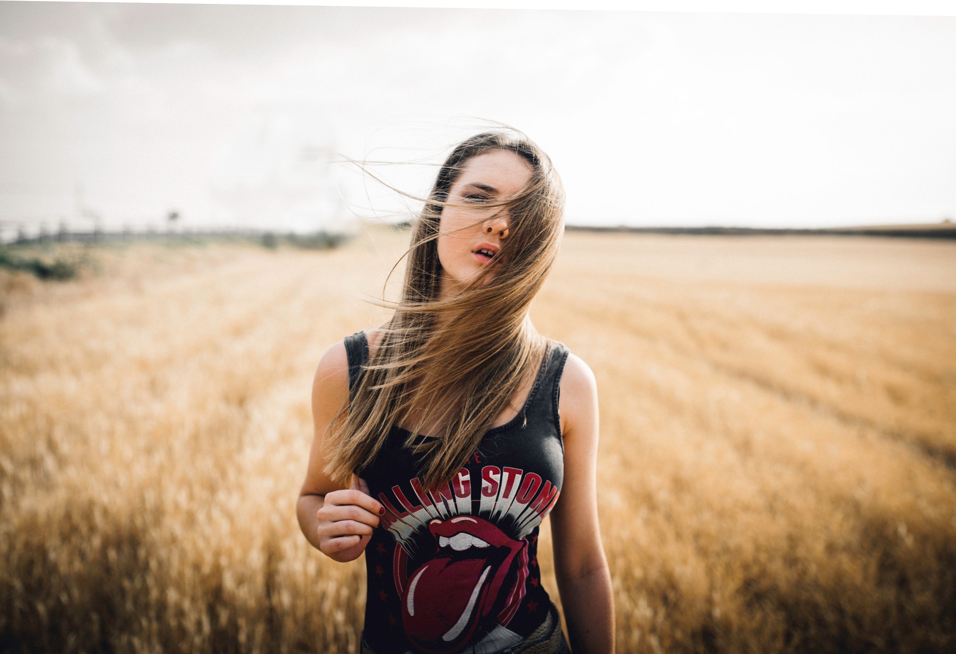 People 1952x1336 women portrait T-shirt women outdoors hair in face depth of field field long hair face photography frontal view Rolling Stones windy rolling stones t-shirt model parted lips