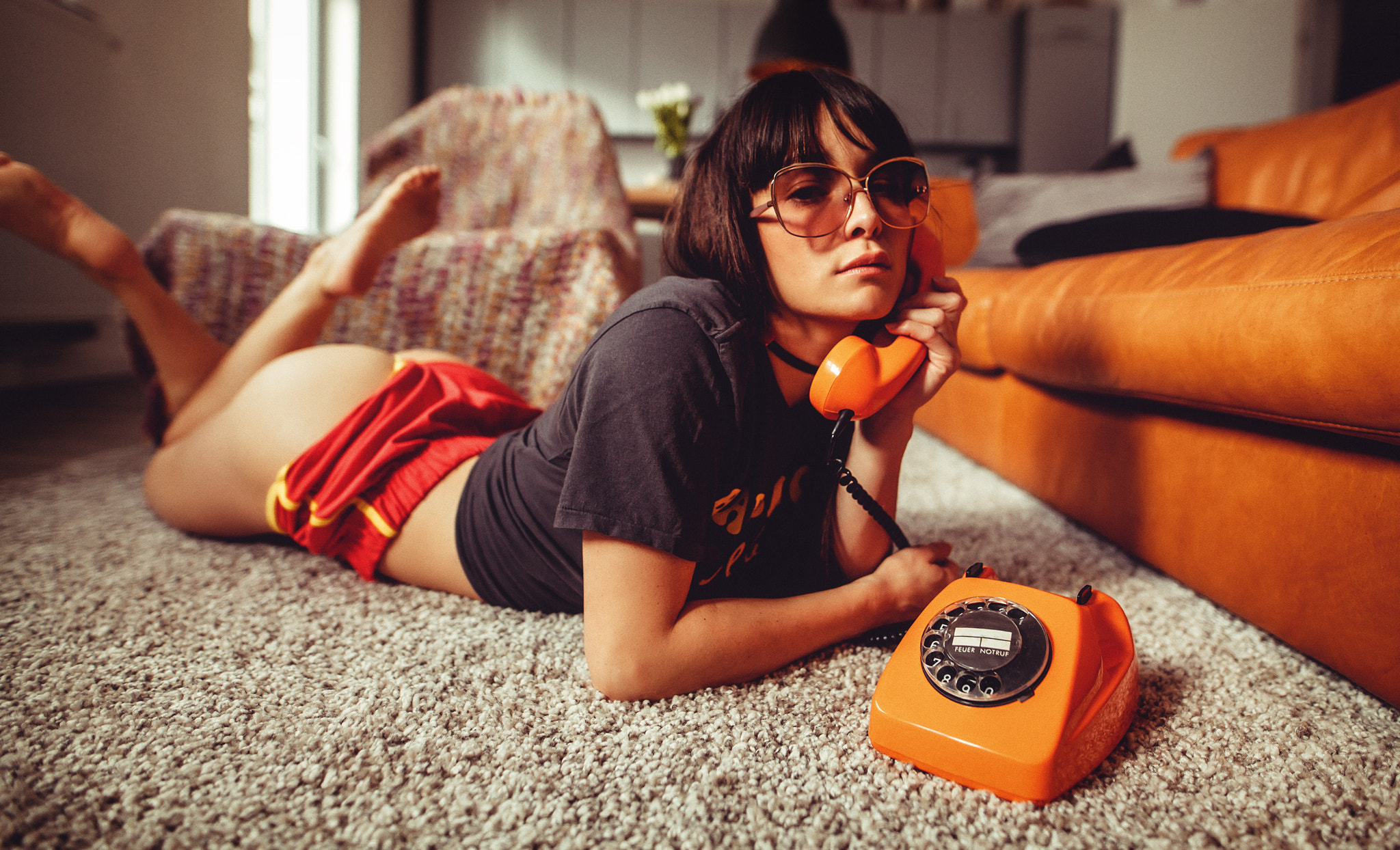 People 2048x1244 women lying on front phone ass T-shirt women with glasses short shorts sunglasses on the floor couch orange