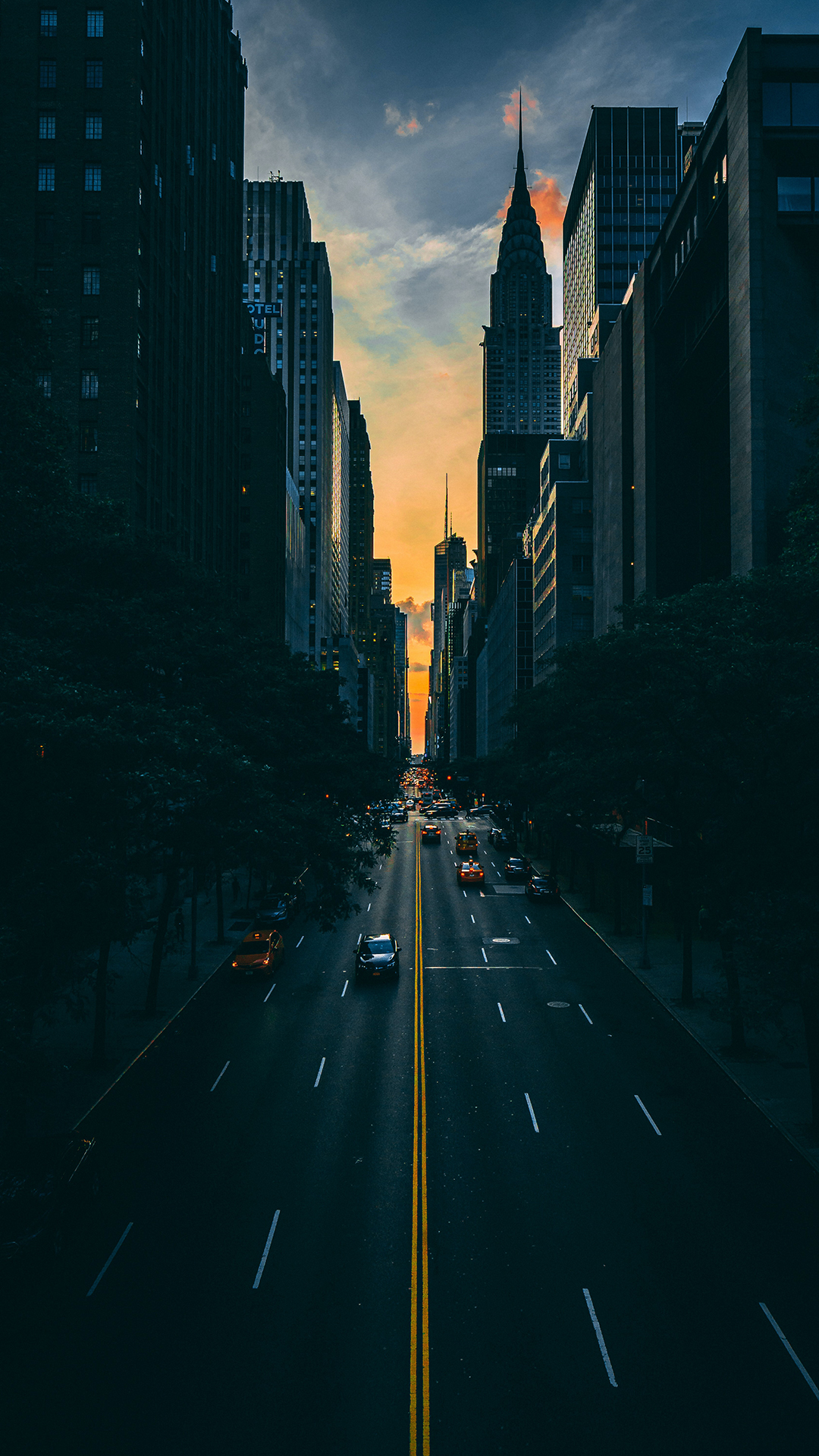 General 1080x1920 New York City urban sunset landscape street portrait display low light building sky clouds vehicle rear view sunset glow trees