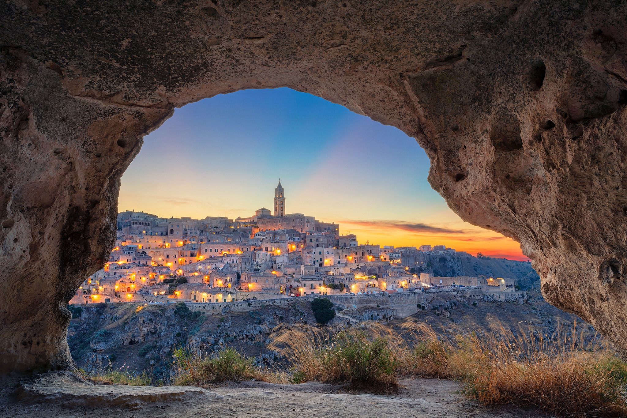 General 2048x1365 Italy Matera cave rocks town shrubs cityscape city lights tower evening