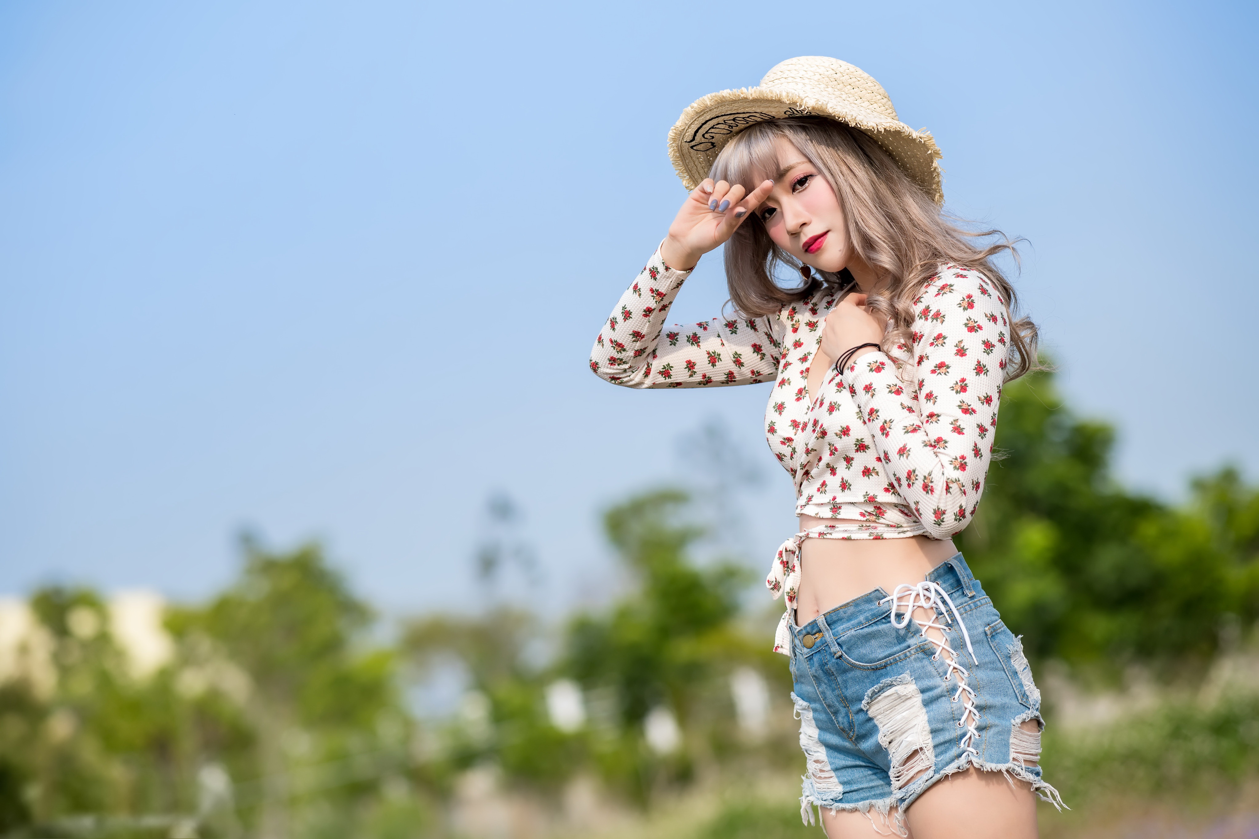 People 4096x2730 Asian model women straw hat shorts bracelets long hair brunette red lipstick looking at viewer belly button shirt hand(s) on head painted nails depth of field trees bushes