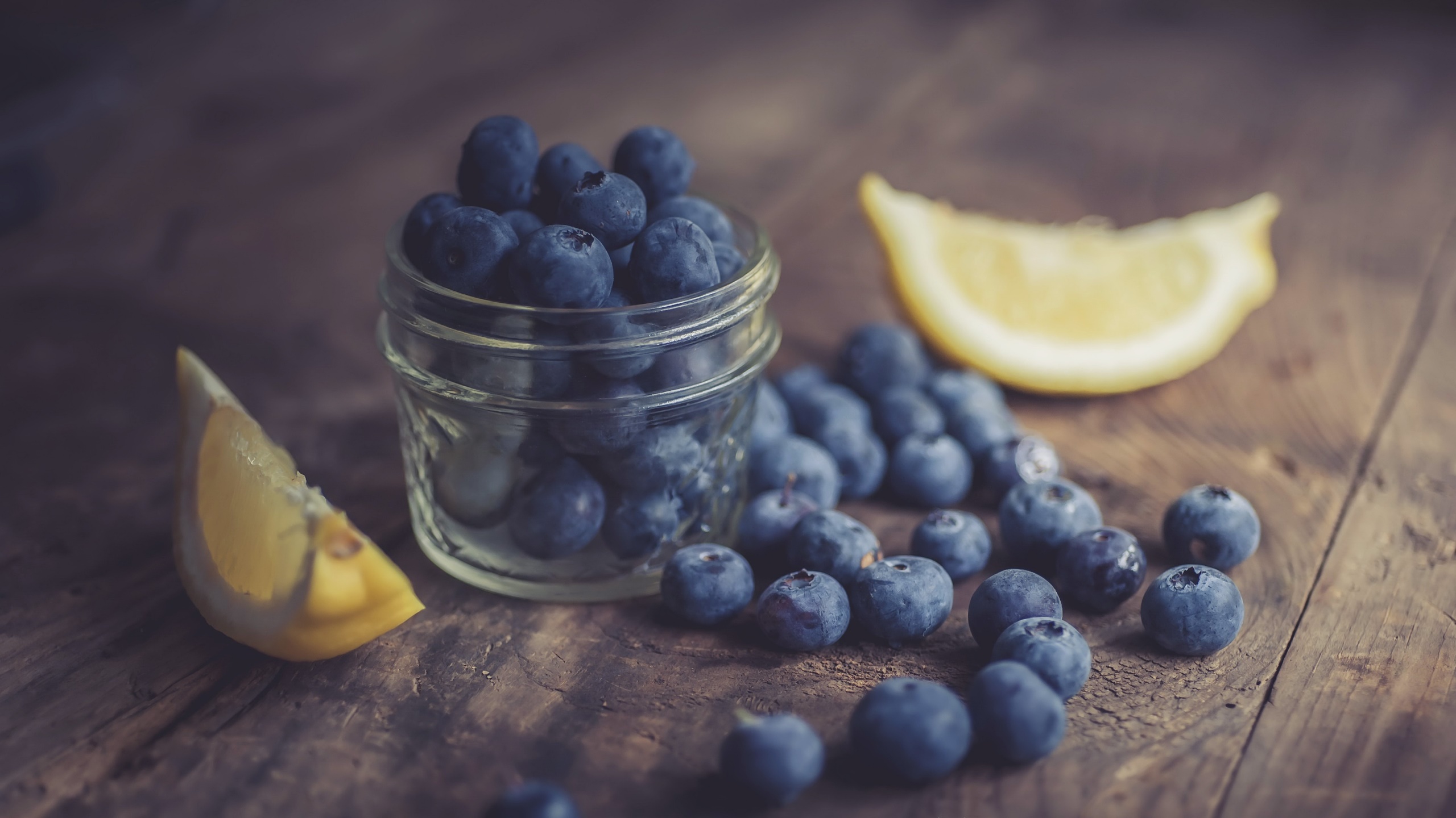 General 2560x1440 food fruit berries blueberries lemons jar wooden surface closeup