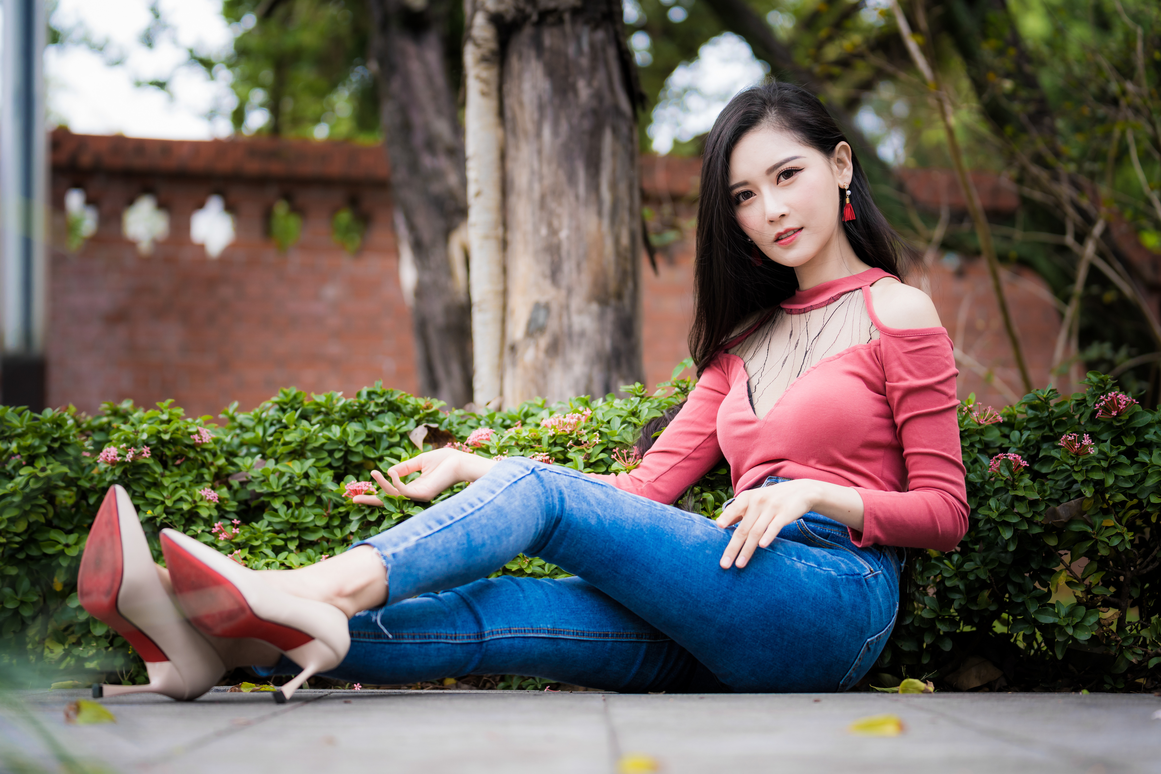 People 3840x2560 Asian model women long hair dark hair sitting jeans heels shirt bushes trees depth of field bricks wall earring