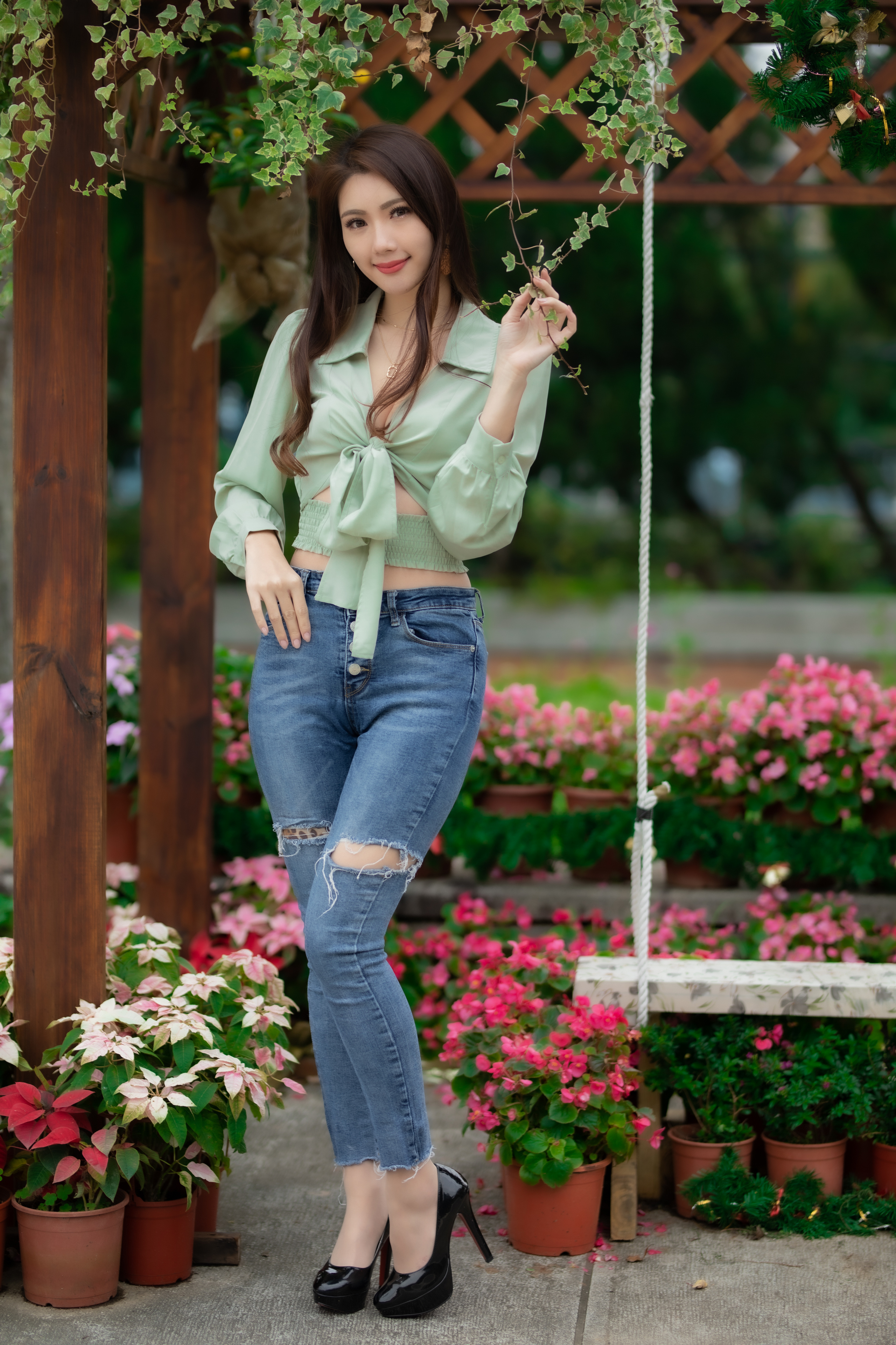 People 2560x3840 Asian model women women outdoors long hair brunette depth of field jeans blouses earring black high-heels flowerpot flowers swings bushes trees necklace