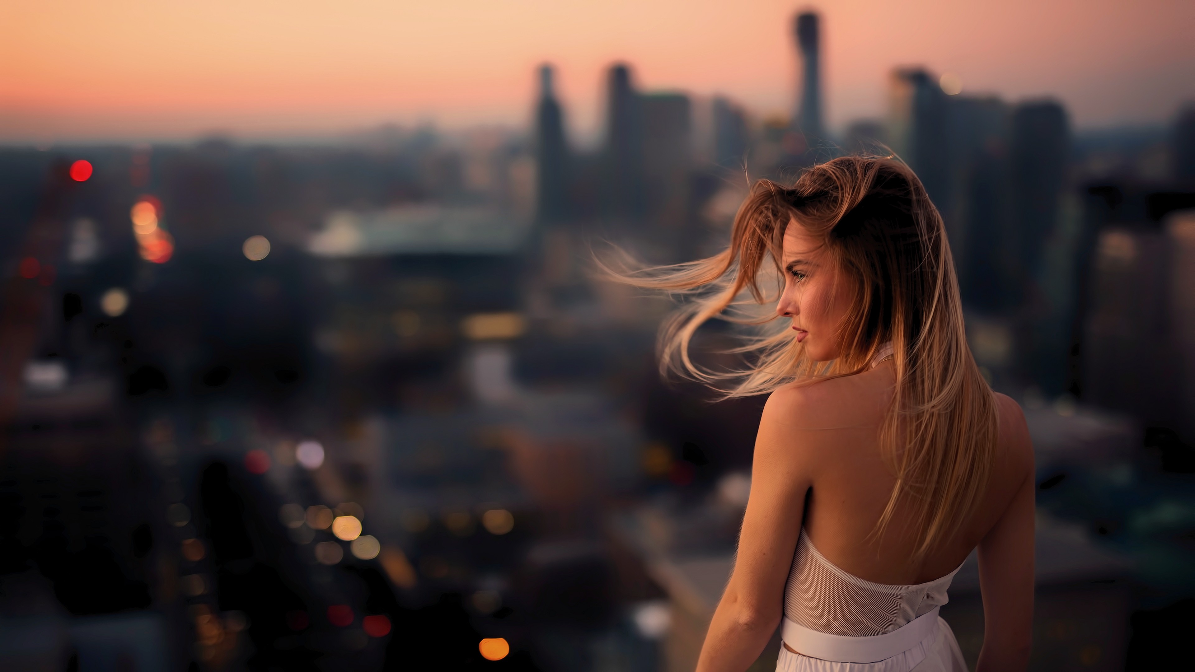 People 3840x2160 women hair   blonde long hair depth of field urban city lights profile strapless dress windy Jesse Herzog color correction hair blowing in the wind rear view looking into the distance back model