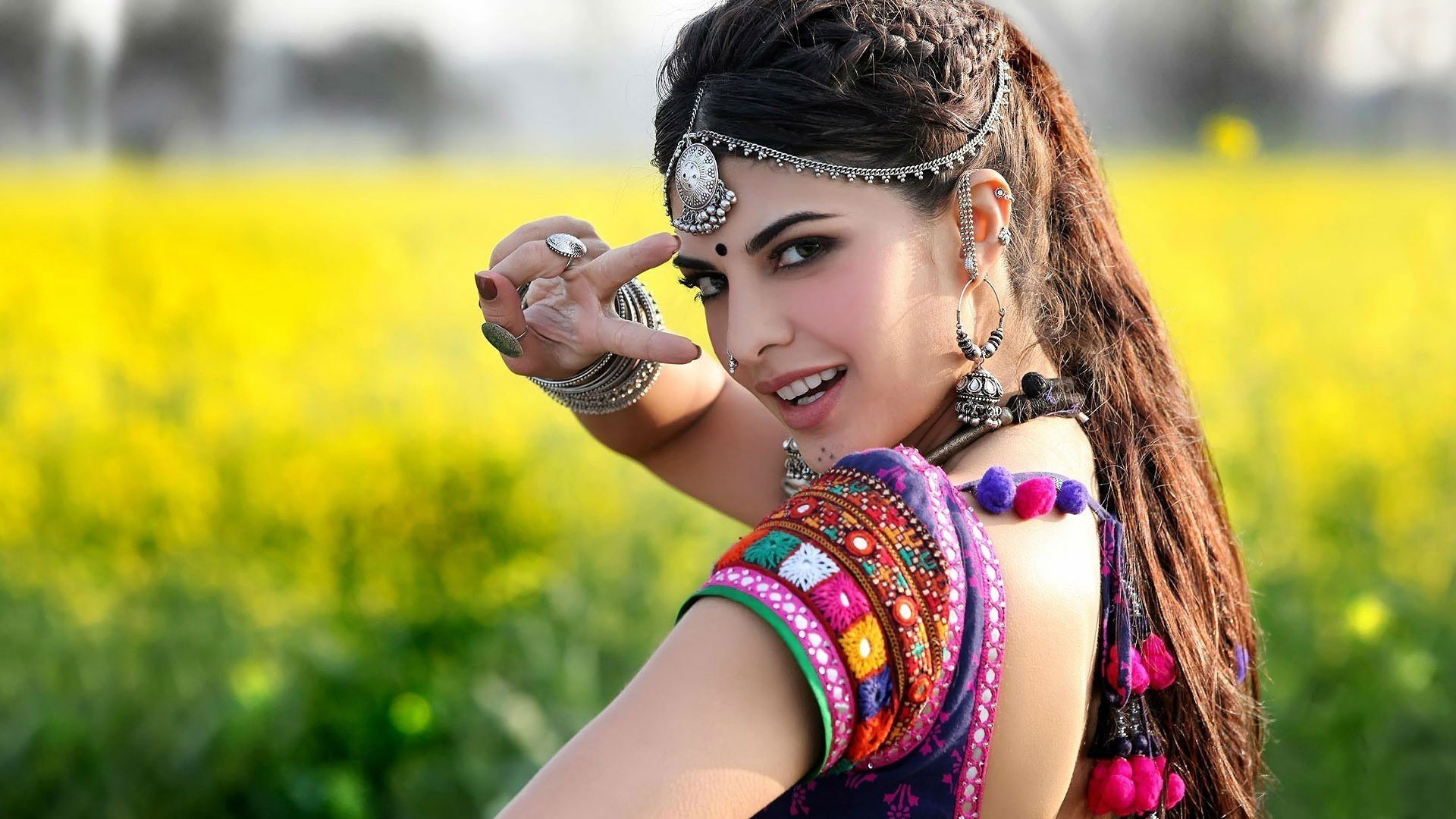 People 1920x1080 women hair ornament traditional clothing face paint earring bracelets brunette indian women eyeliner makeup open mouth hand gesture yellow background looking at viewer model red nails piercing