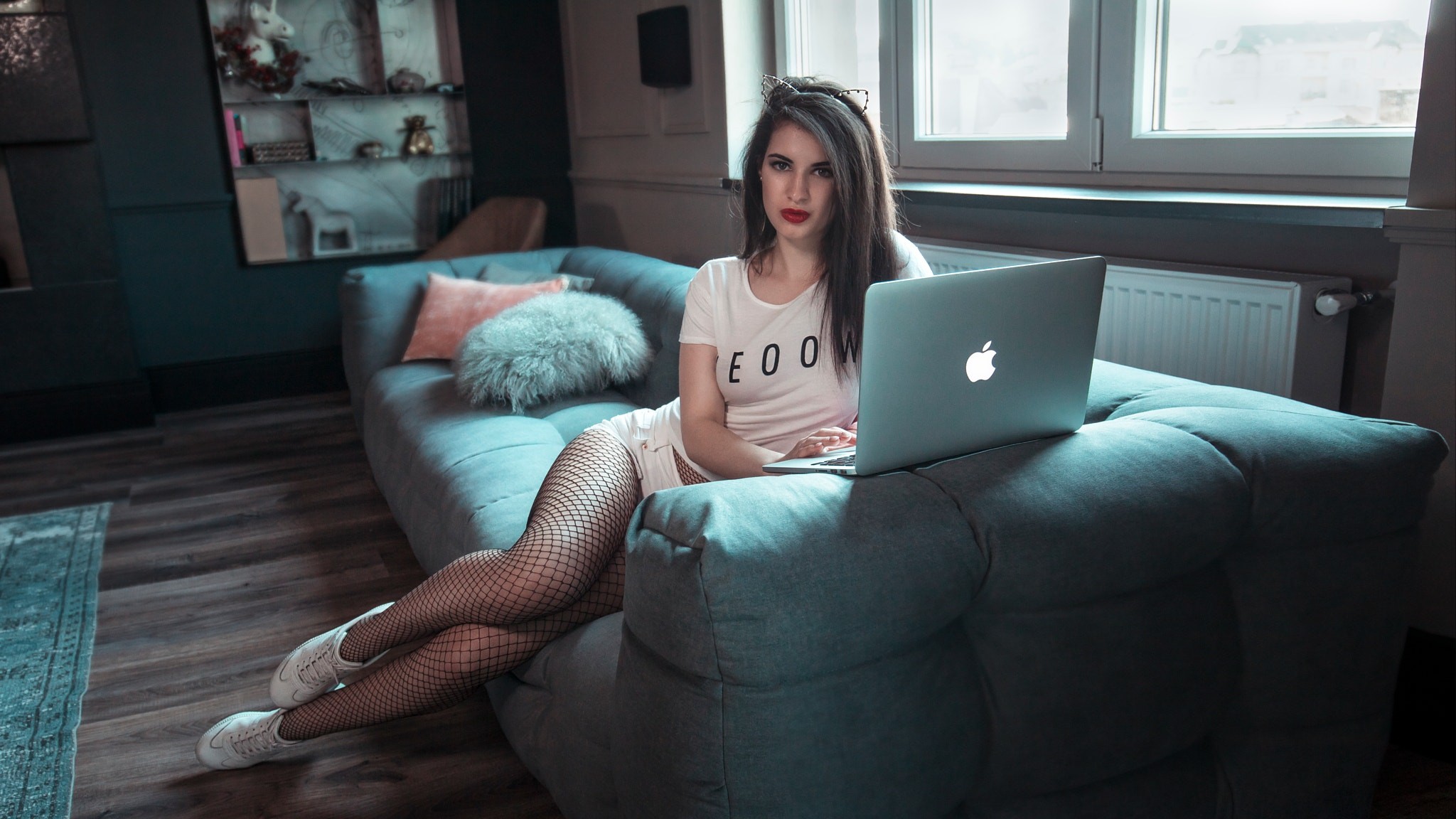 People 2048x1152 Anna Wolf women sitting sneakers fishnet stockings T-shirt laptop jean shorts red lipstick cat ears MacBook Peter Jordanoff whole body couch