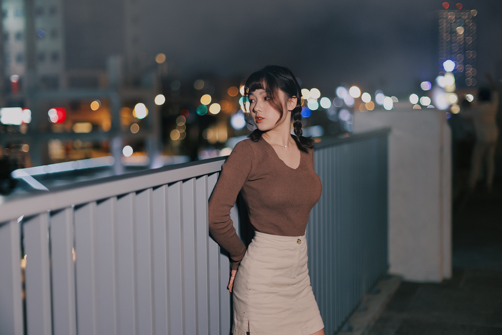 People 2048x1366 Asian model women long hair brunette grey skirt leaning railing twintails night sky depth of field city lights looking into the distance brown sweater