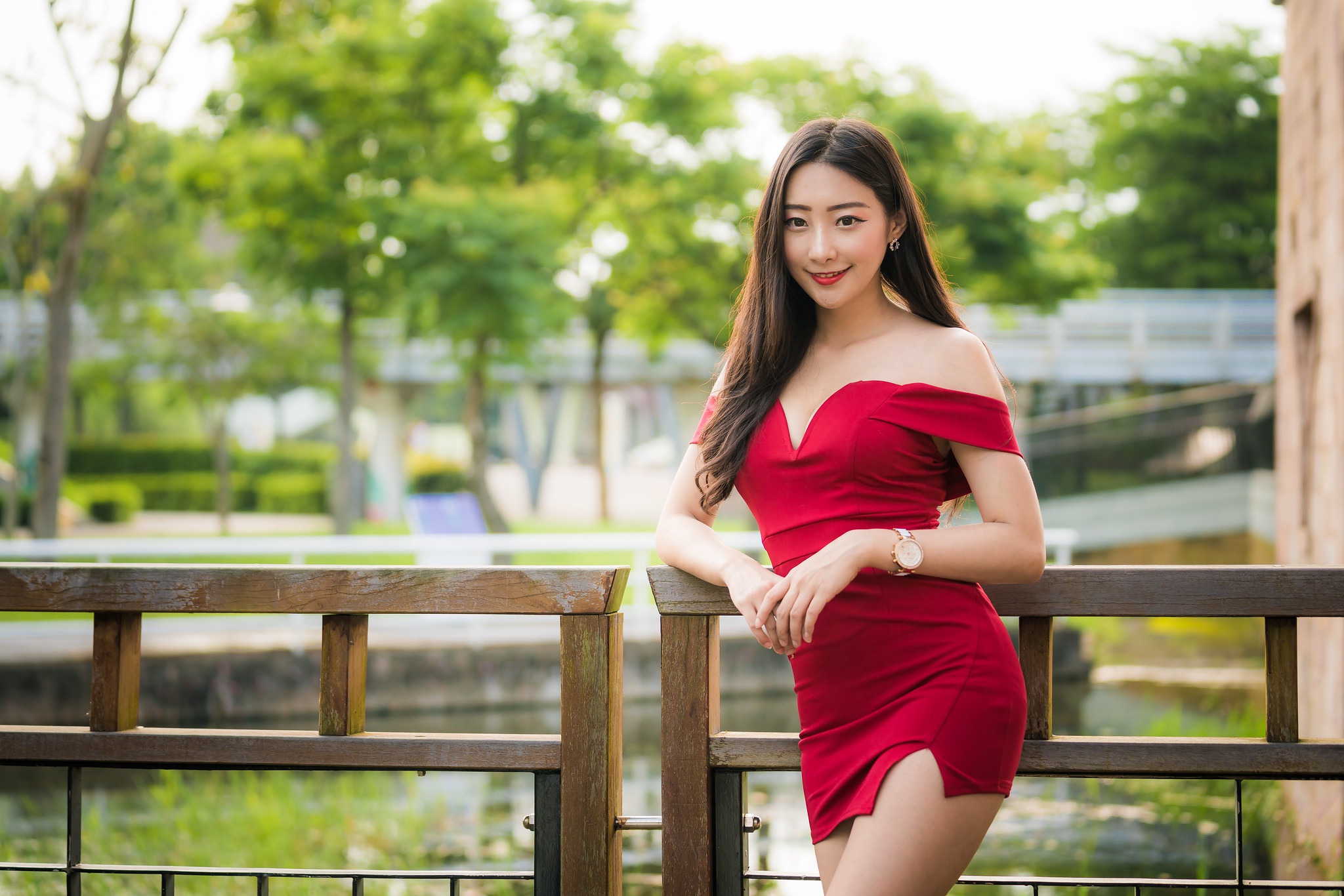 People 2048x1366 Asian women model long hair brunette depth of field red dress minidress leaning railing trees bridge pond bushes wristwatch earring red lipstick
