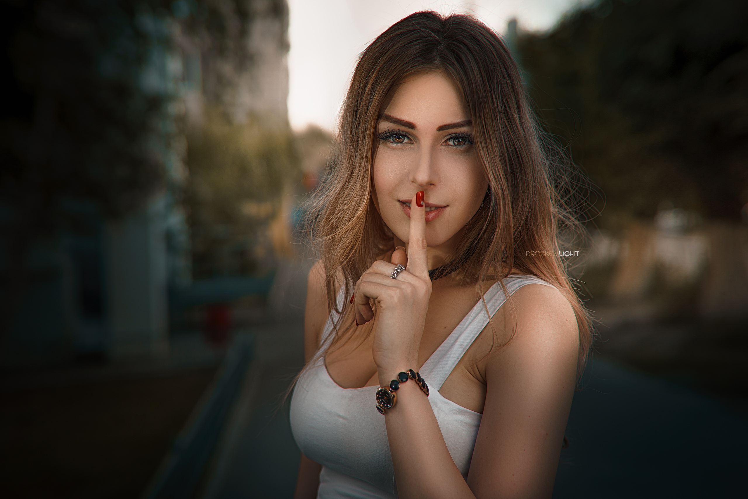 People 2560x1707 women model brunette portrait outdoors looking at viewer white tops red nails watch finger on lips depth of field women outdoors smiling Alexander Drobkov silence