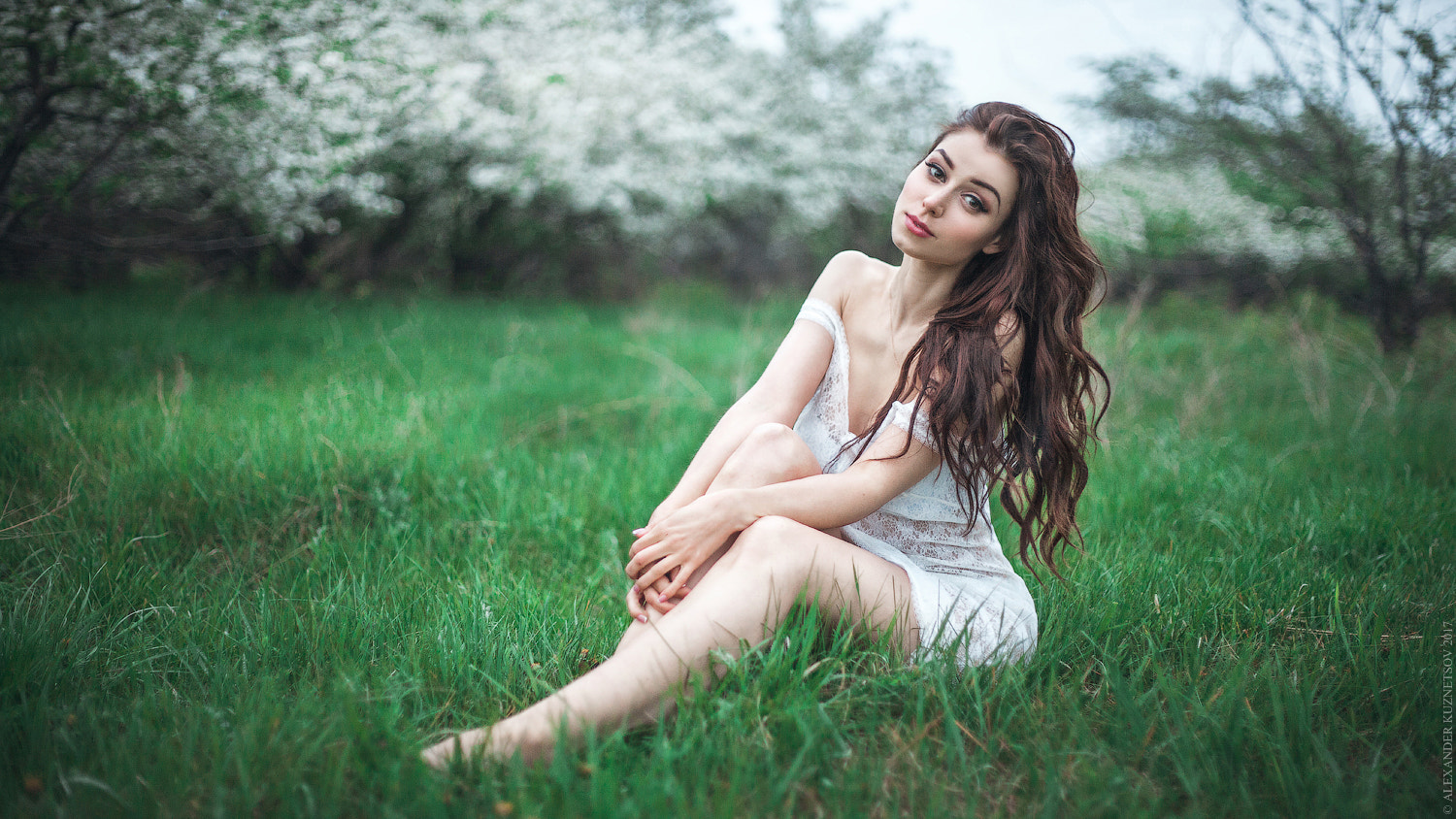 People 1500x844 Alexander Kuznetsov women brunette long hair wavy hair bare shoulders outdoors grass legs looking at viewer makeup see-through clothing cleavage lace barefoot long eyelashes eyeliner lipstick smiling model women outdoors