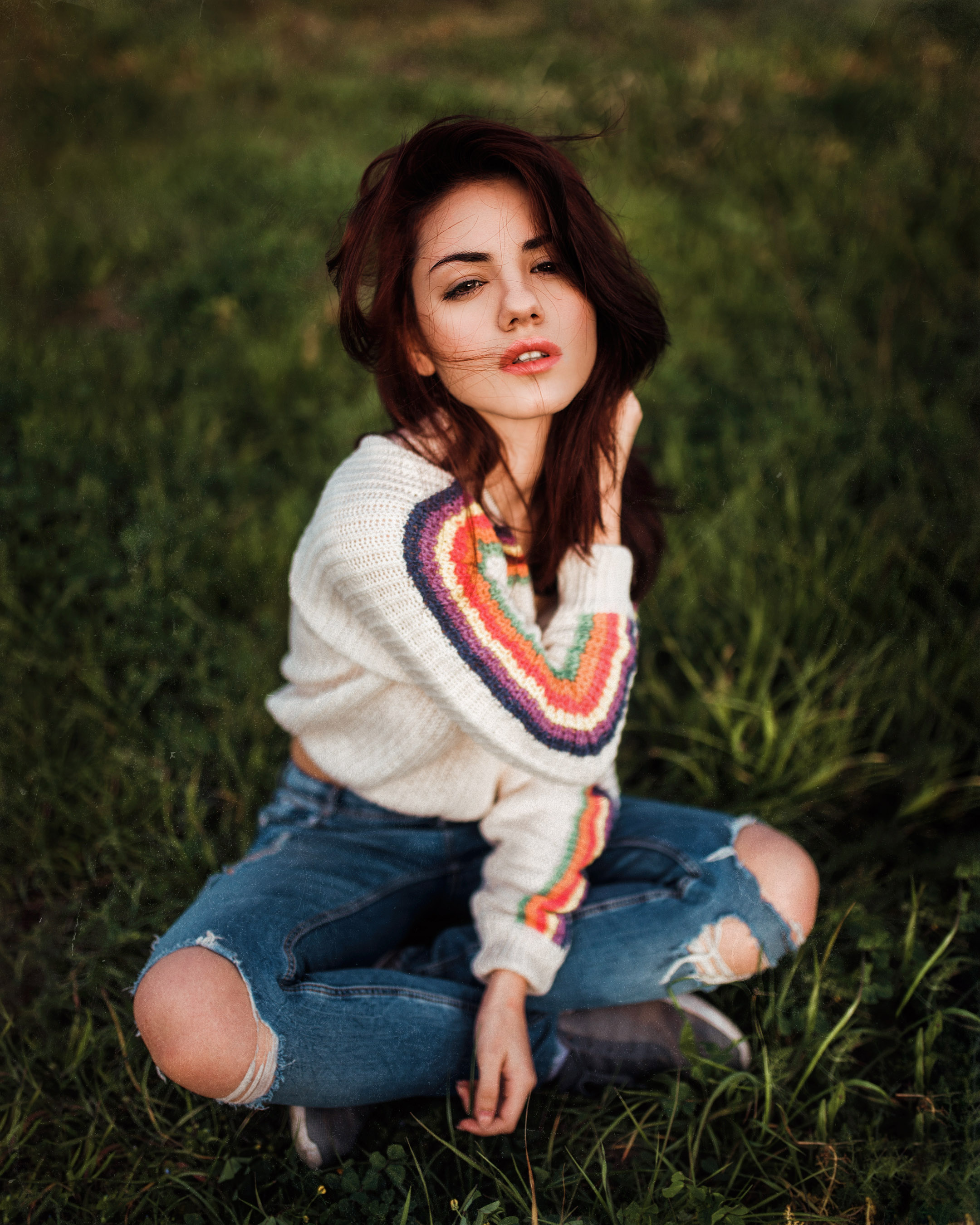 People 2160x2700 Delaia Gonzalez women model brunette hair in face touching hair looking at viewer sensual gaze parted lips sweater jeans torn jeans sitting legs crossed bokeh depth of field grass portrait display outdoors women outdoors Gustavo Terzaghi