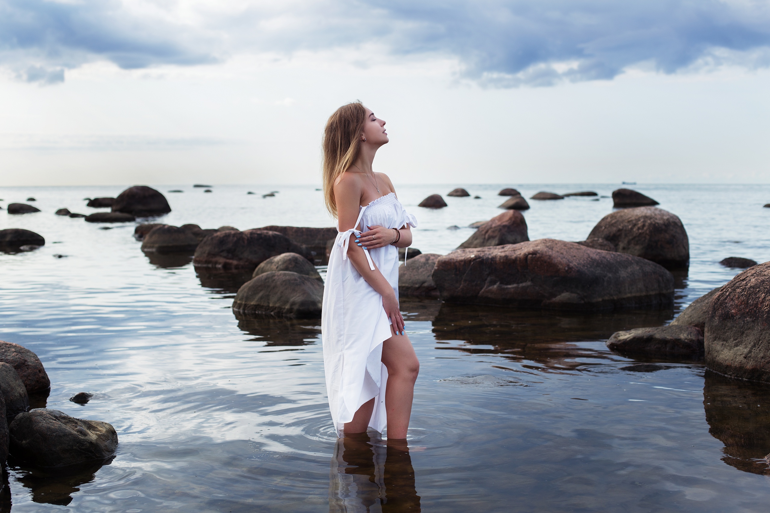 People 2560x1707 women model closed eyes profile smiling necklace bare shoulders dress white dress white clothing standing painted nails in water water sea rocks clouds sky horizon landscape depth of field nature outdoors women outdoors side view